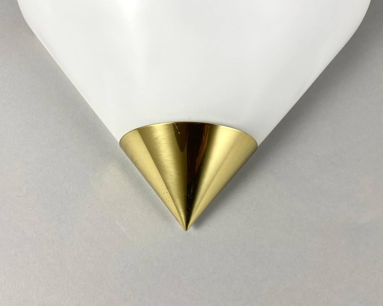 Beautiful set of opaline hand-blown glass design wall lamps with brass fixture from the 1970s/80s from the German Glashütte Limburg.

Mid-Century Modern wall sconces with beautiful conical shape.

Original label intact on both lamps.

The