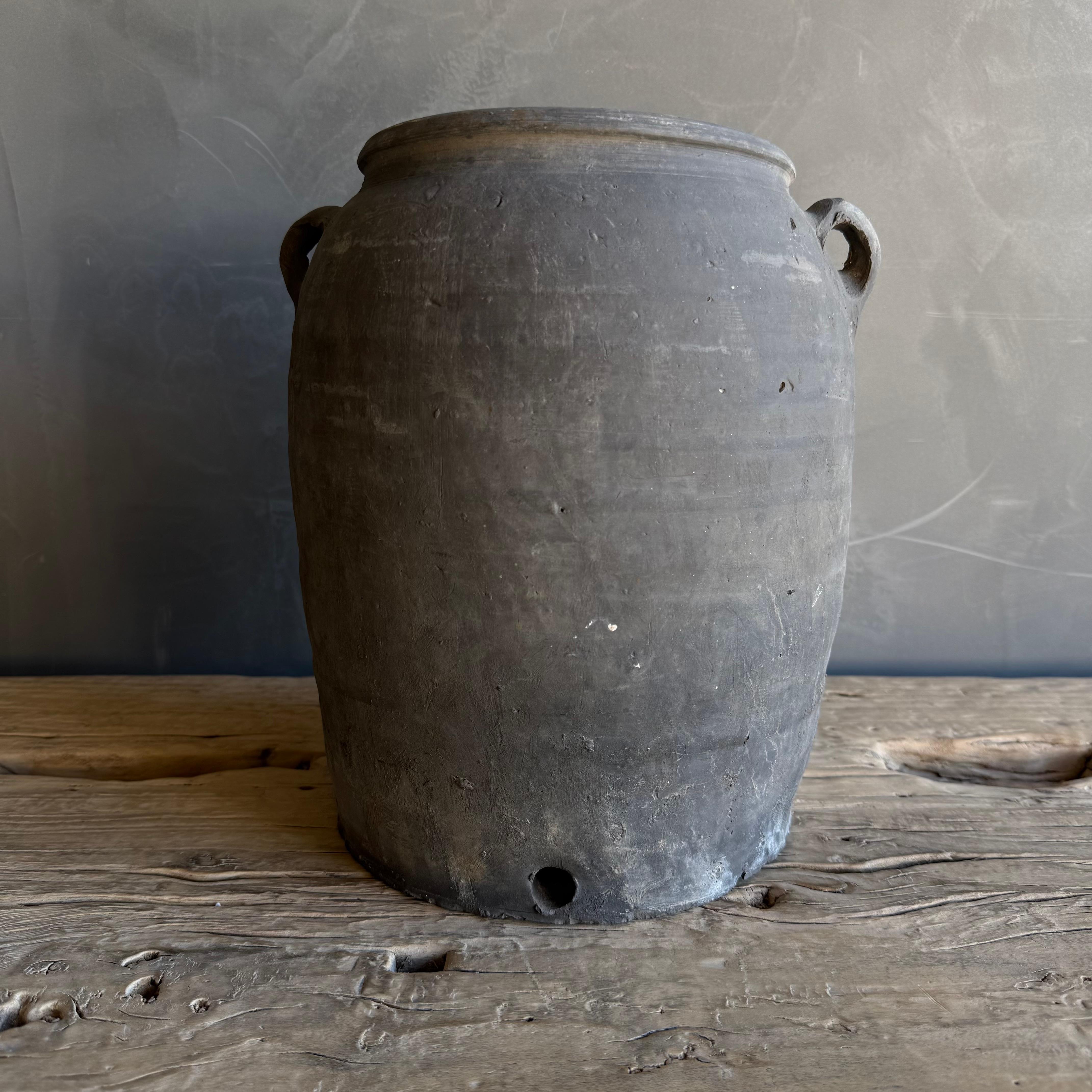 This exquisite vintage clay pottery piece showcases a stunning matte gray finish that beautifully accentuates its unique texture. The surface features captivating variations in color, giving it a rustic charm and depth that makes each piece truly