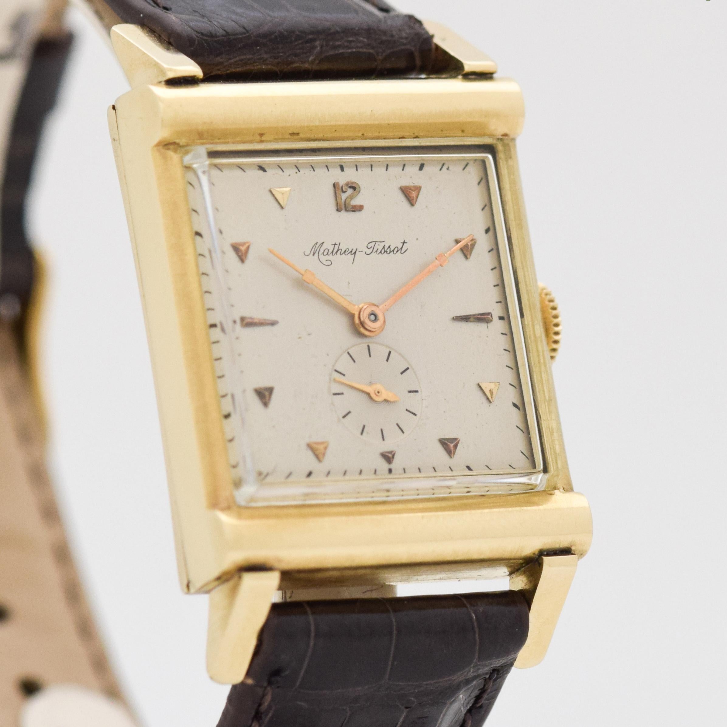 1940'S Vintage Mathey Tissot 14k Yellow Gold watch with Original Silver Dial with Applied Gold Arabic 12 with Beveled Triangle and Elongated Triangle Markers. 25mm x 40mm lug to lug (0.98 in. x 1.57 in.) - 17 jewel, manual caliber movement. Triple