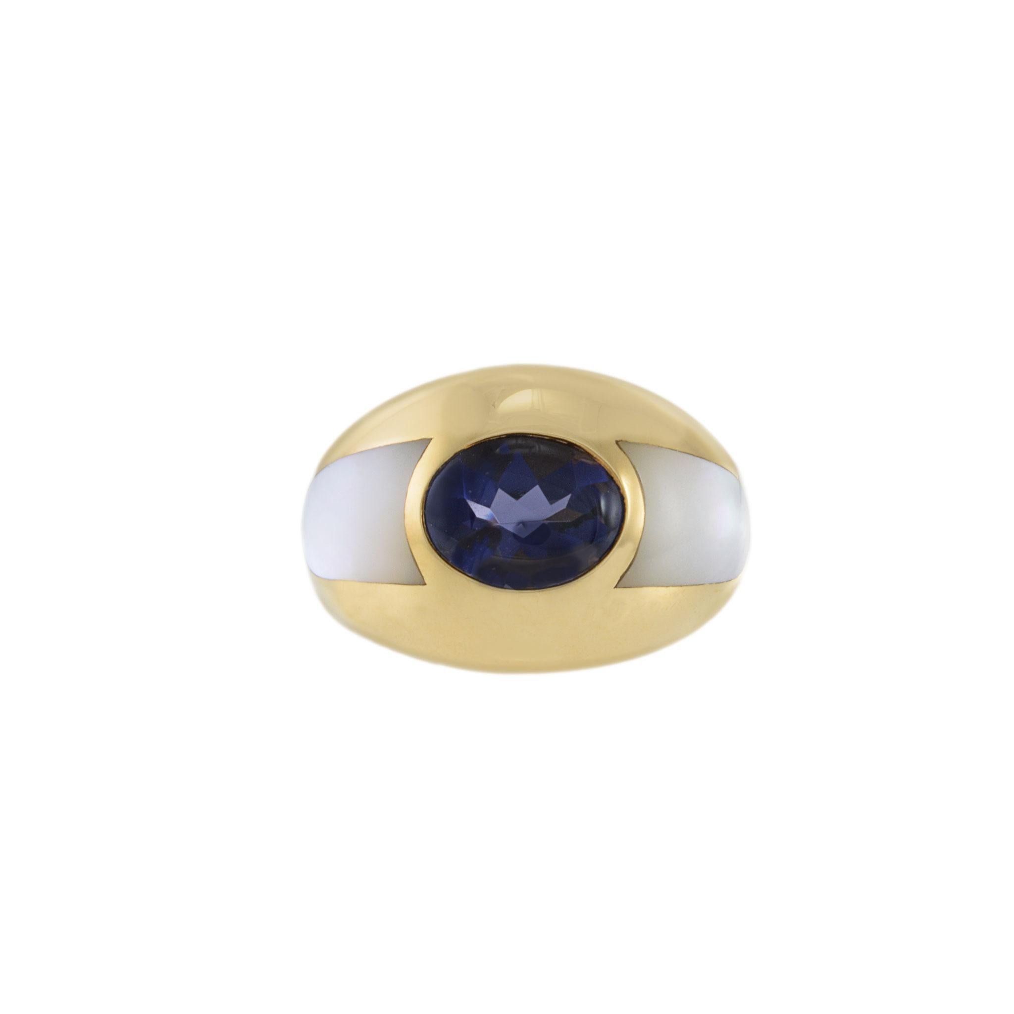 Adorn yourself with elegance through this stunning Mauboussin ring, featuring a captivating mother of pearl and cabochon blue iolite dome design. Perfect for any special occasion, this vintage piece crafted in 18kt yellow gold is a timeless addition