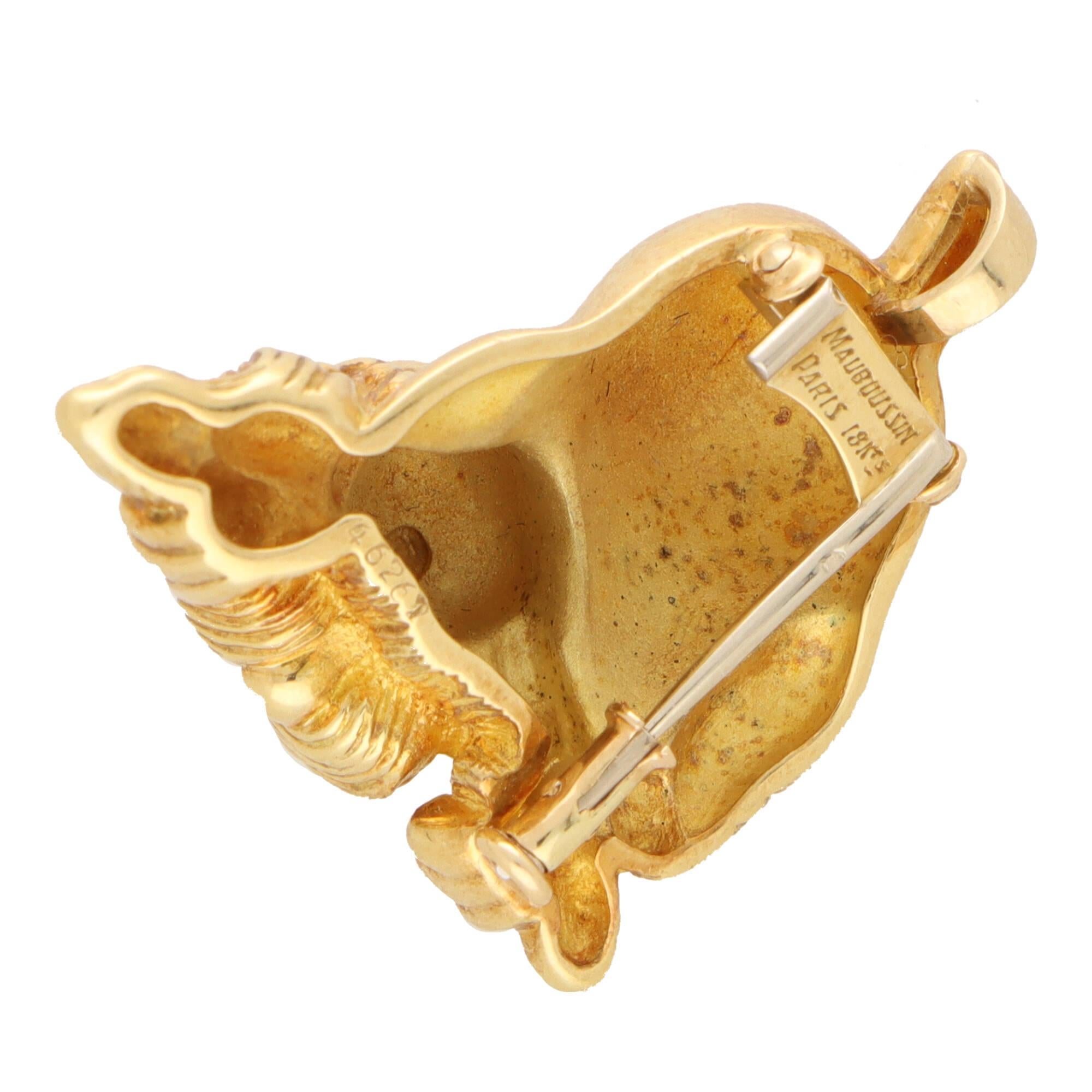 A beautiful vintage Mauboussin sapphire eyed dog brooch set in 18k yellow gold.

The brooch depicts a playing dog with its tail up in the air. The dogs body has been beautifully crafted with hand engraved detailing around the face and paws. Lastly