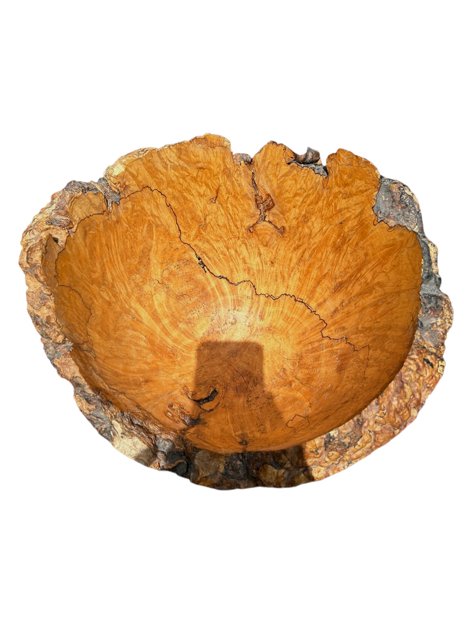 This vintage burl bowl is a unique addition to any collection or kitchen.  Hand-turned by Maurice Gamblin in New Brunswick, Canada.  It showcases a beautiful natural pattern that makes it perfect for display or use.  The bowl is crafted with