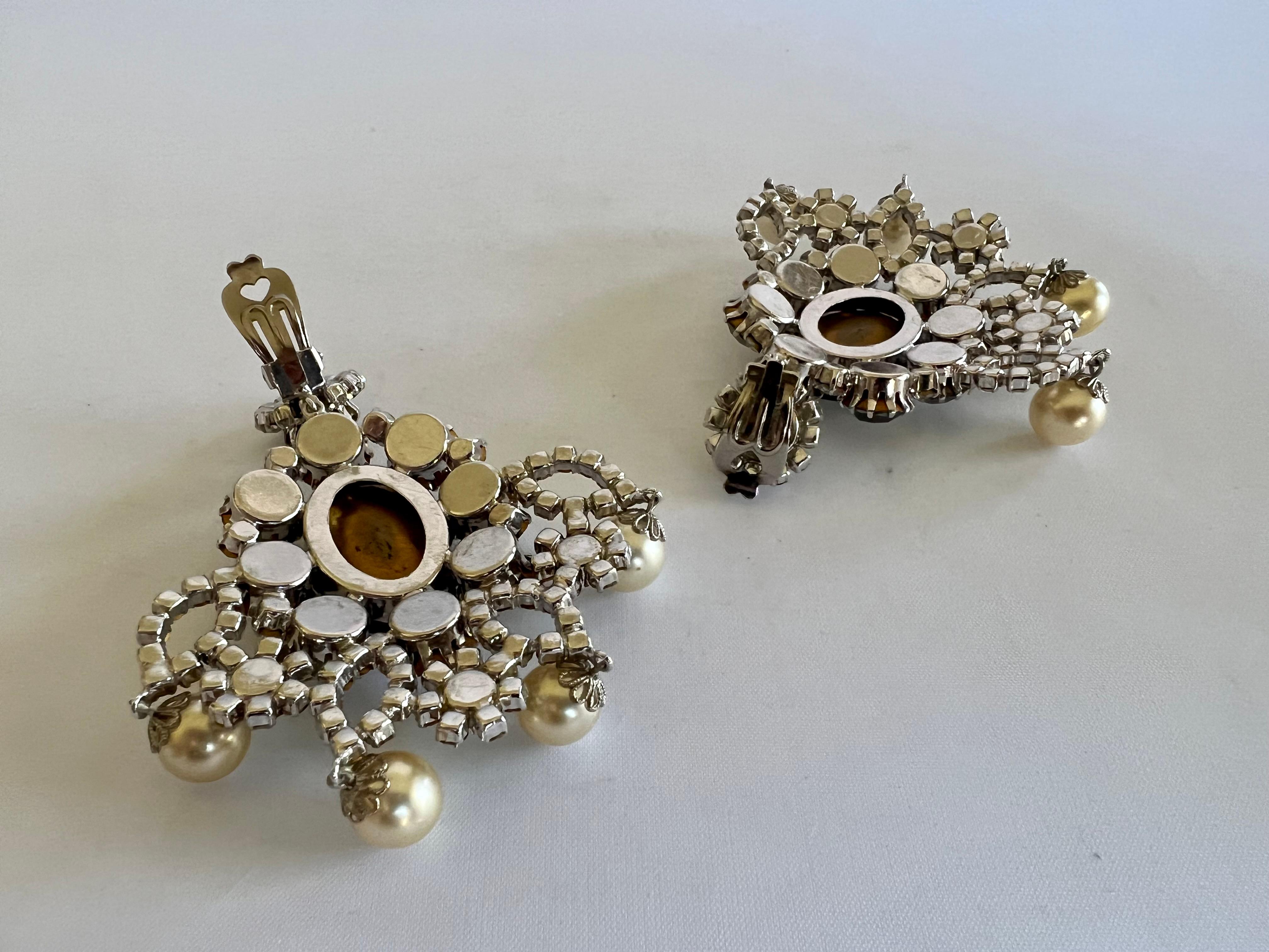 Vintage 1960's Max Muller Kaufbeuren clip-on statement earrings. Extremely rare 1960s unsigned Max Muller crystal, faux emerald, and pearls.
 Max Muller was a German jewelry designer who designed and manufactured for couture houses such as Christian