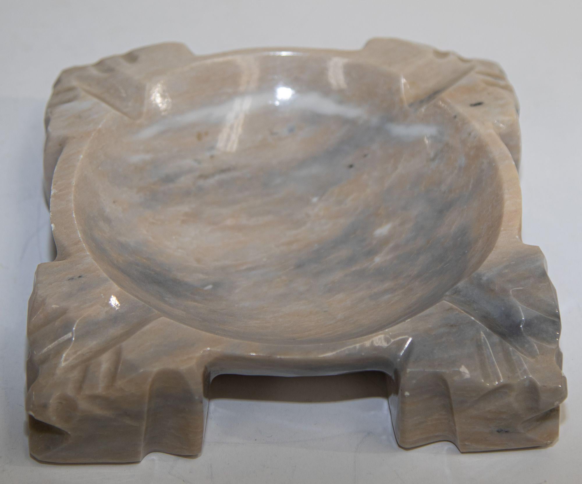Vintage brown marble square ashtray Mayan Aztec hand carved in natural earth tones.
Great Post Modern style design on this hand carved polished marble, large ashtray circa 1960s-70s hand carved on each corner with some Aztec figures.
The ashtray is