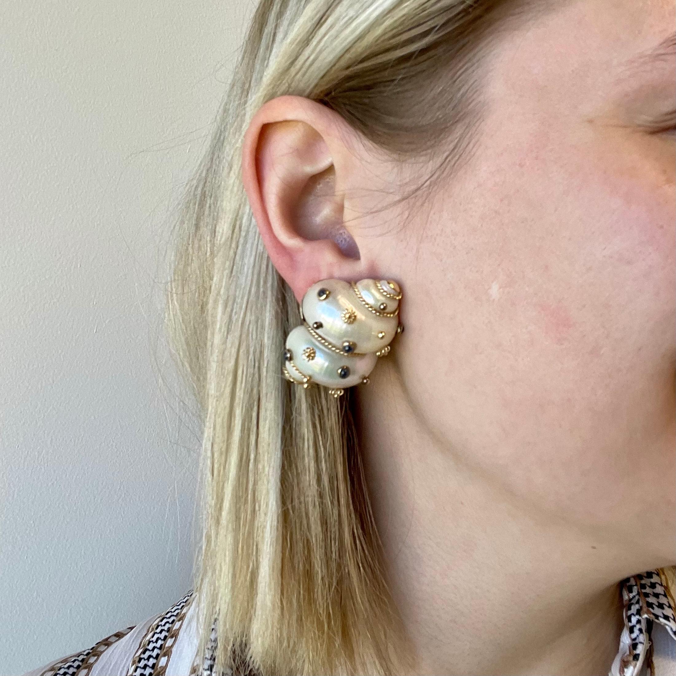 Ear clips were a hot trend during the 1960's and now it's an iconic accessory once again; especially if they're  vintage. Stay on top of the fashion trends with these Vintage Maz created Sapphire 14k Gold Mother Of Pearl Seashell Earrings. 

The