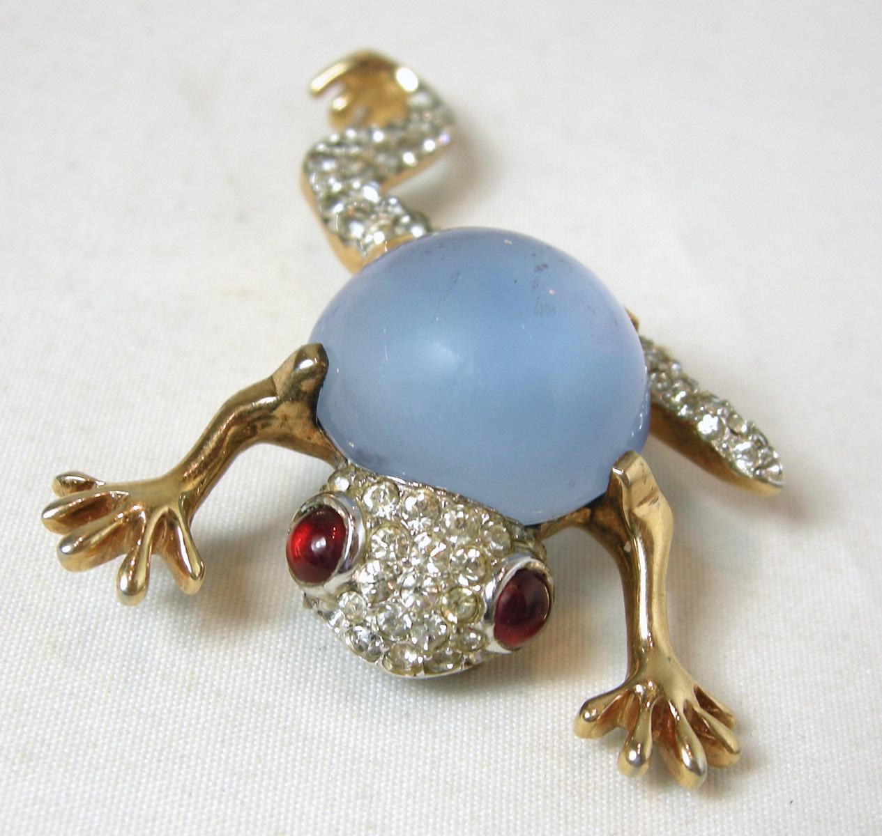 This is Mazer’s famous frog fur clip with the blue jelly belly body.  Its head and legs have clusters of clear rhinestones and its eyes have ruby crystals … all in a gold tone setting.  It is signed “Mazer” twice … on the clip and on its leg.  It