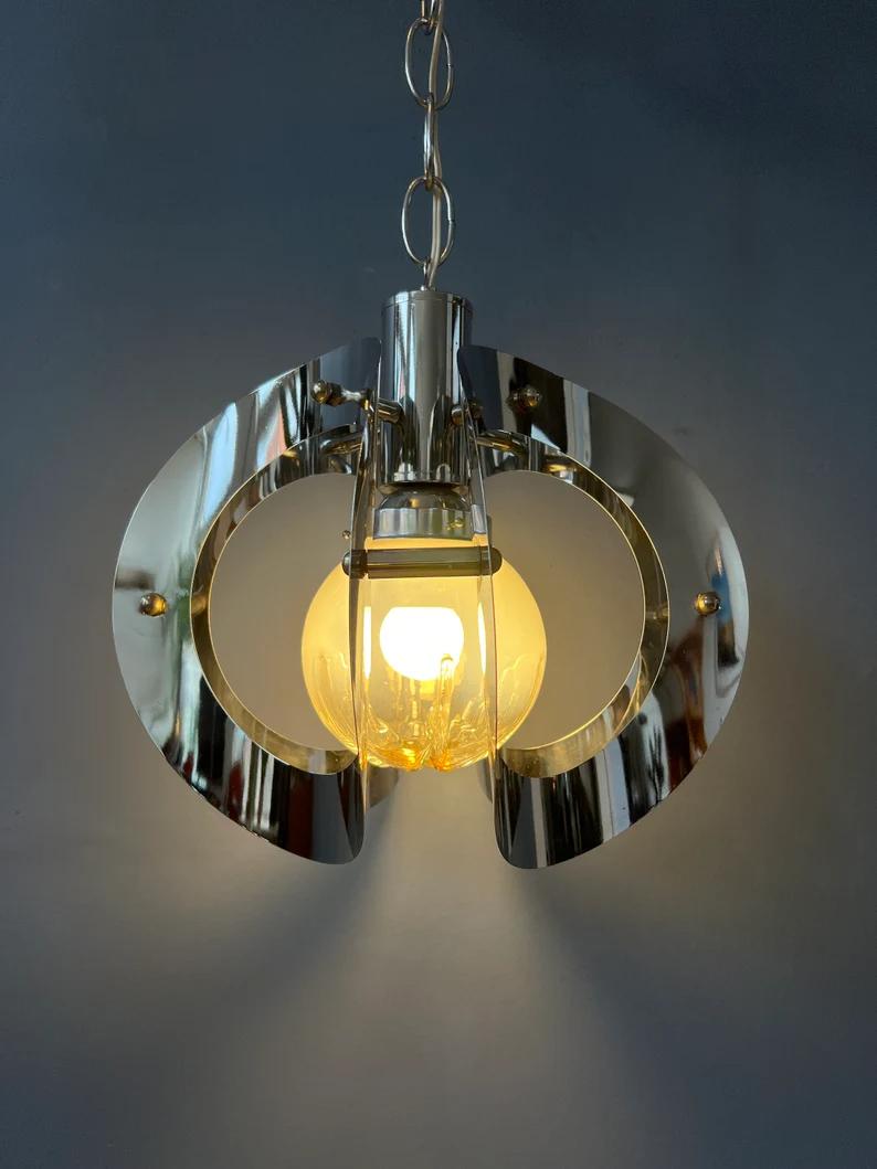 Very rare vintage pendant lamp by Mazzega with murano glass shade. The lamp consists of a shiny, chrome frame and an inner murano glass shade. The lamp requires one small E27 (standard) lightbulb.

Additional information:
Materials: Glass,