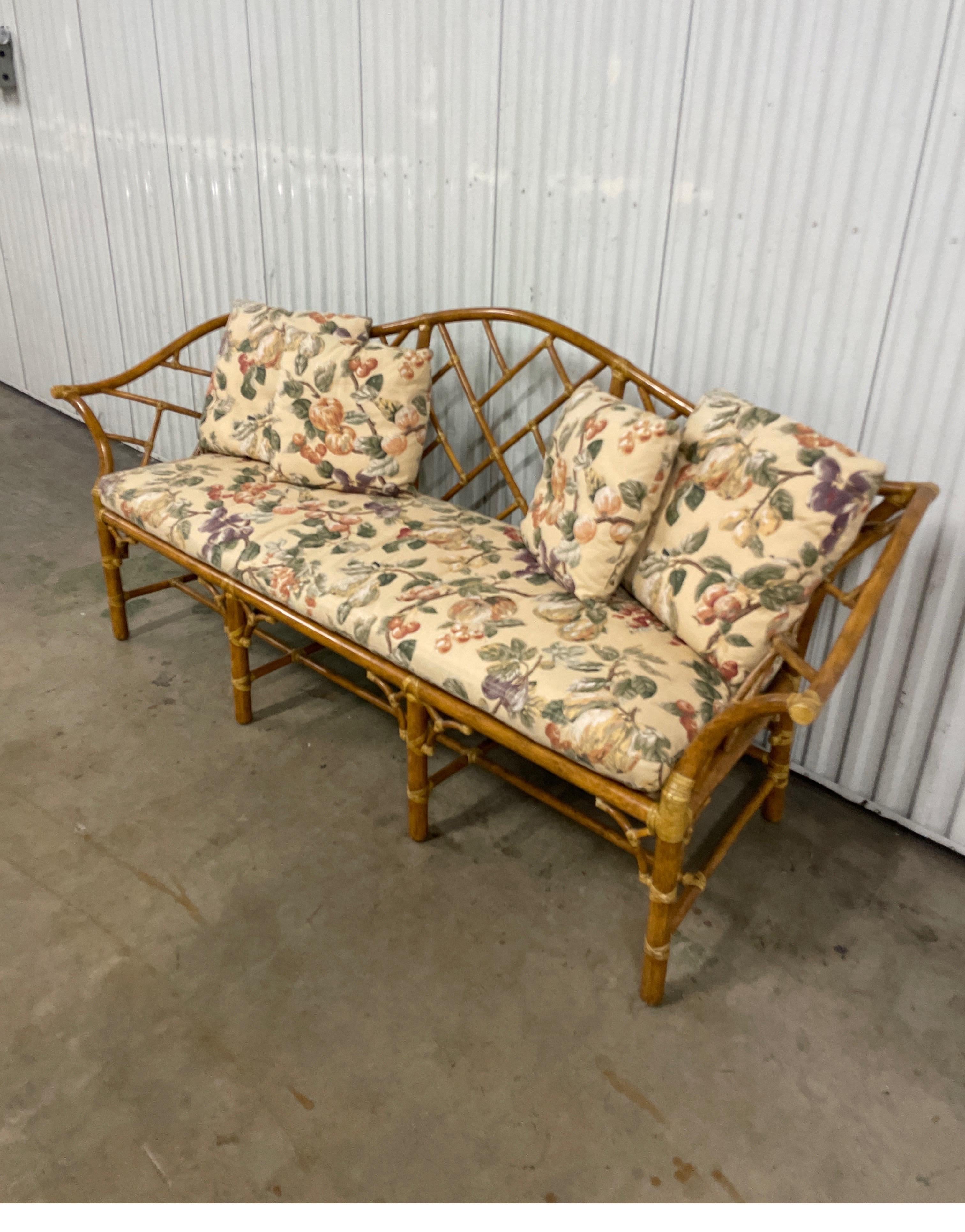 Vintage Mc Guire bamboo & rattan Chinoiserie style sofa in natural color. Very well detailed sofa with stretchers and rolled arms. The 84.5