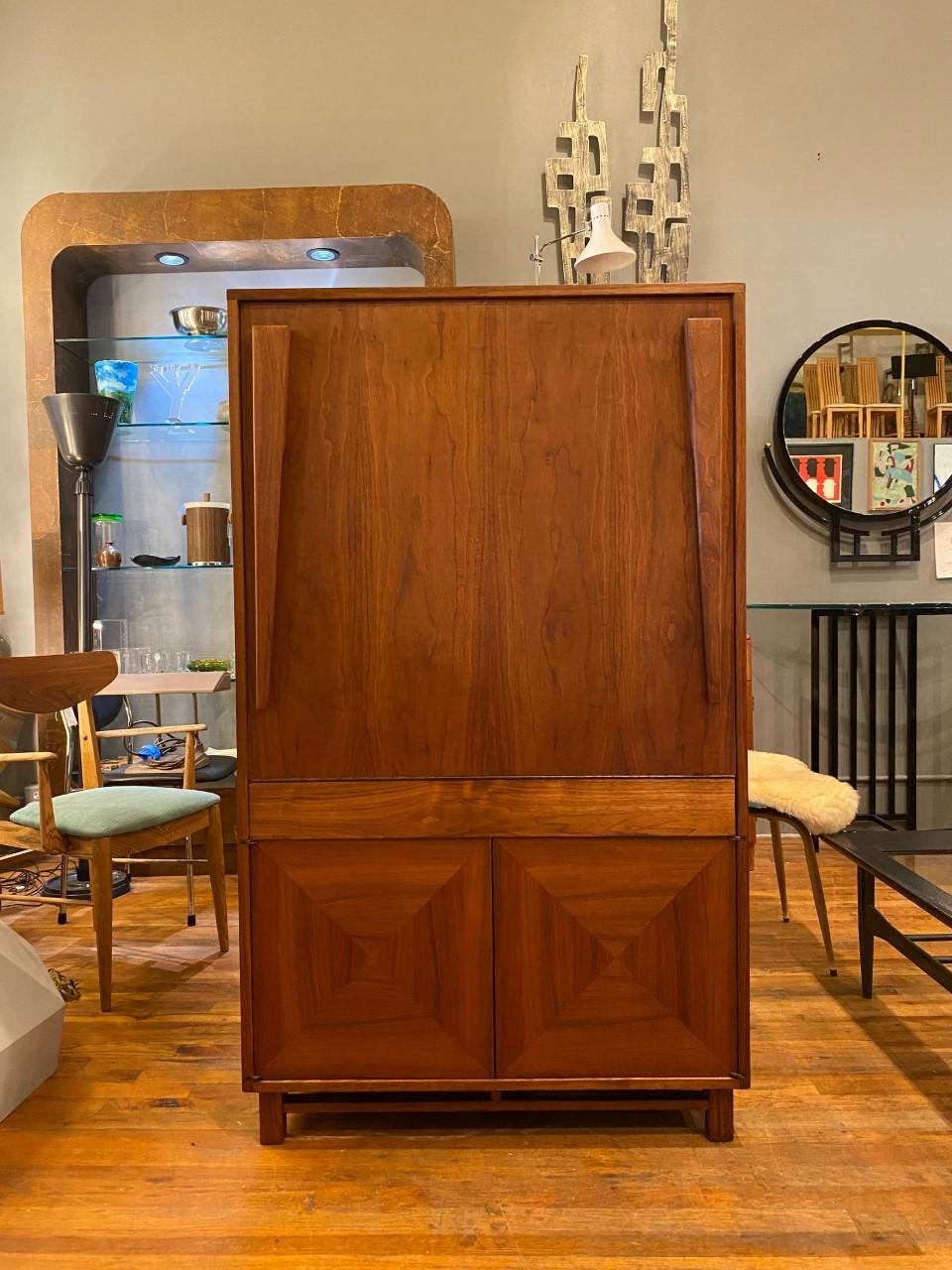 Incredible and intelligent design by John Keal for Brown Saltman. This incredible vintage cabinet from the late 1950s transcends decades to amaze with intelligent design and purpose. On the outside, the cabinet is minimal and clean lined with two