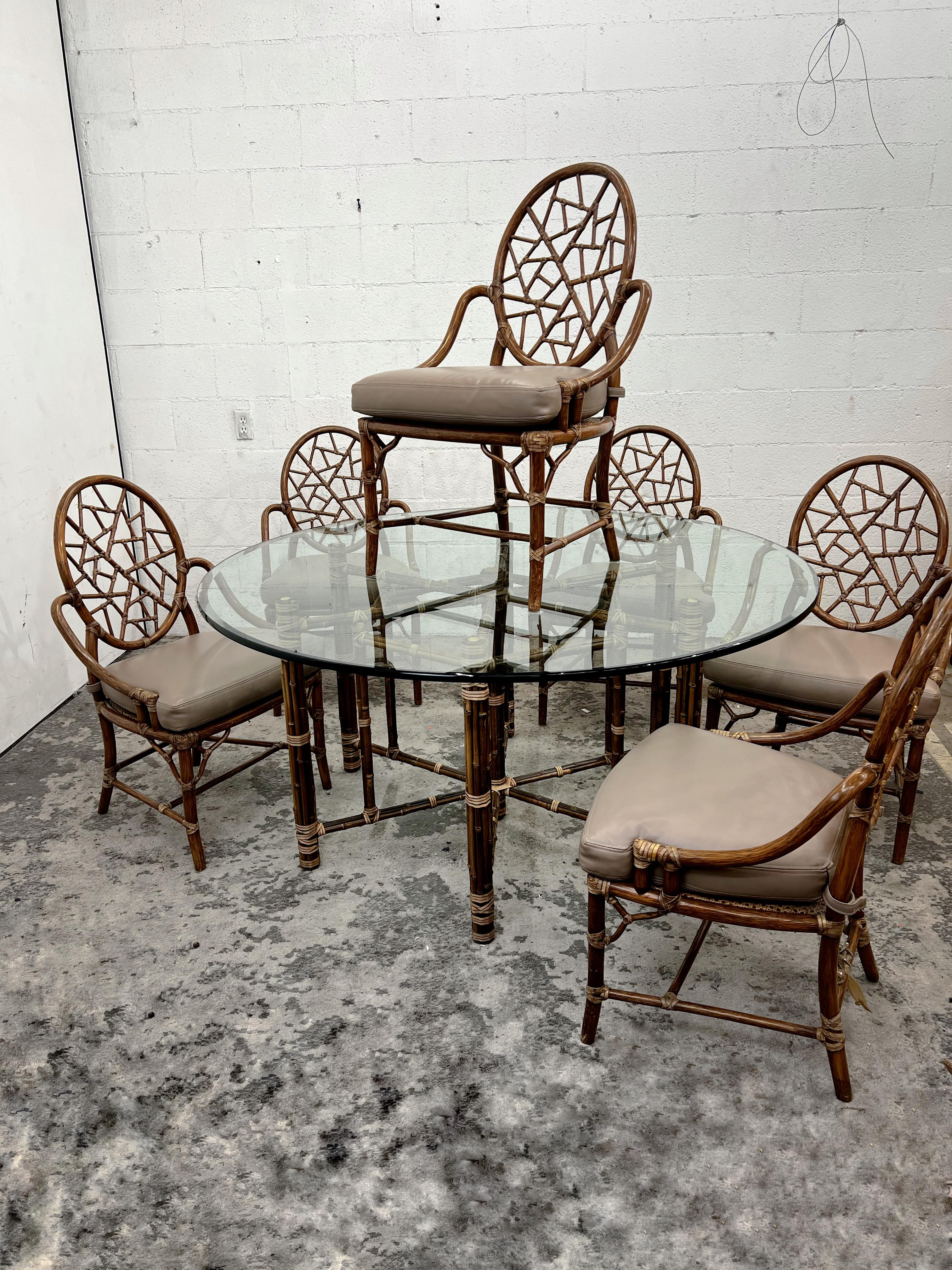 Vintage McGuire dining set, six cracked ice dining chairs and 60” dining table, rattan and bamboo and raw hide

The table was designed by Leonard Linden. 60