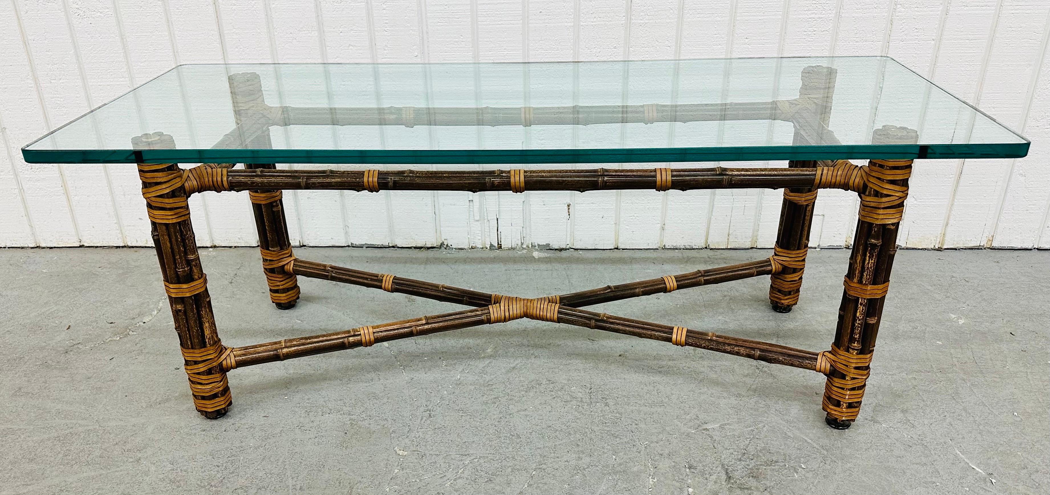 This listing is for a vintage McGuire Faux Bamboo Glass Top Coffee Table. Featuring a boho chic design, thick rectangular glass top, and a faux bamboo base. This is an exceptional combination of quality and design by McGuire!