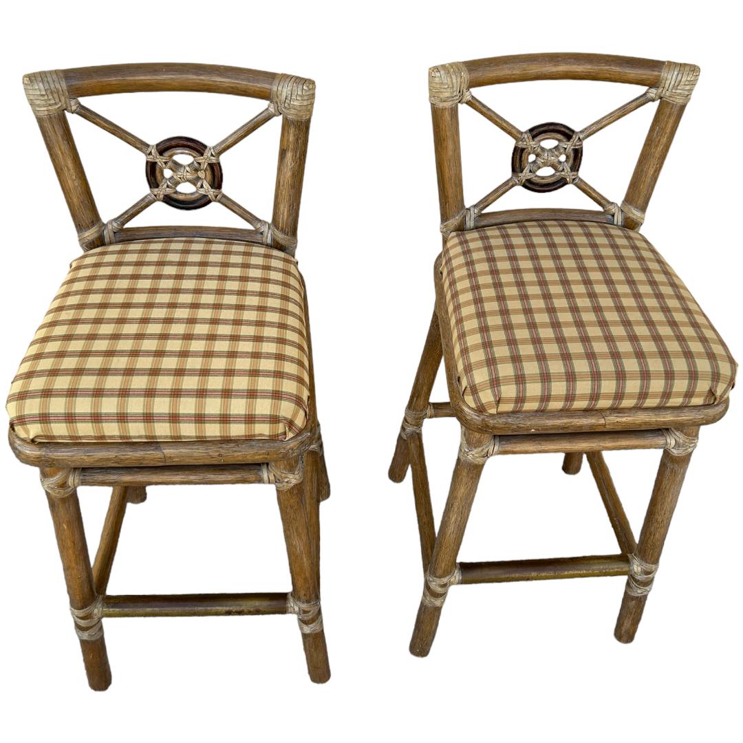 Bring a touch of retro elegance to your home with these vintage McGuire rattan bar stools. Crafted with exquisite attention to detail, these bar stools boast a beautiful rattan frame that exudes natural charm and character. The set comes complete