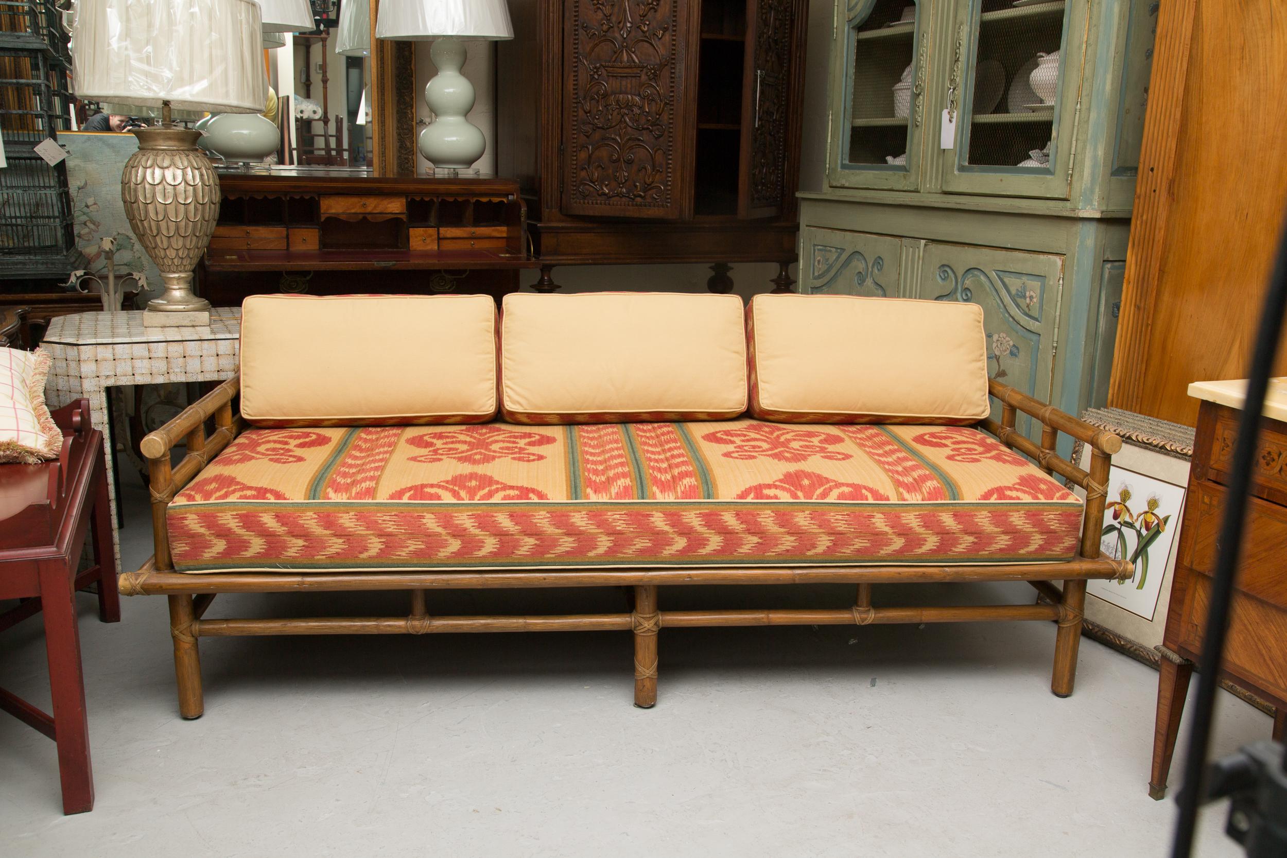 This vintage McGuire rattan daybed has been lovingly restored with new support webbing and upholstery, circa 1950.