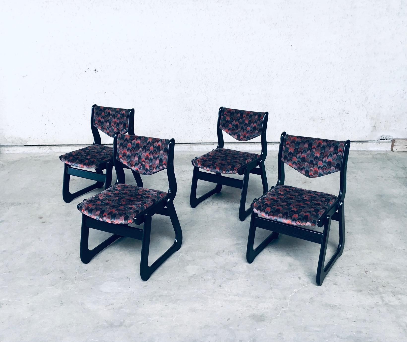 Vintage Mid-Century Modern design set of 4 black stained laquered wood dining or kitchen chairs. Made in the 1970's. No maker markings. Black stained wooden frame with multicolored fabric seat and back. These are in very good condition. All