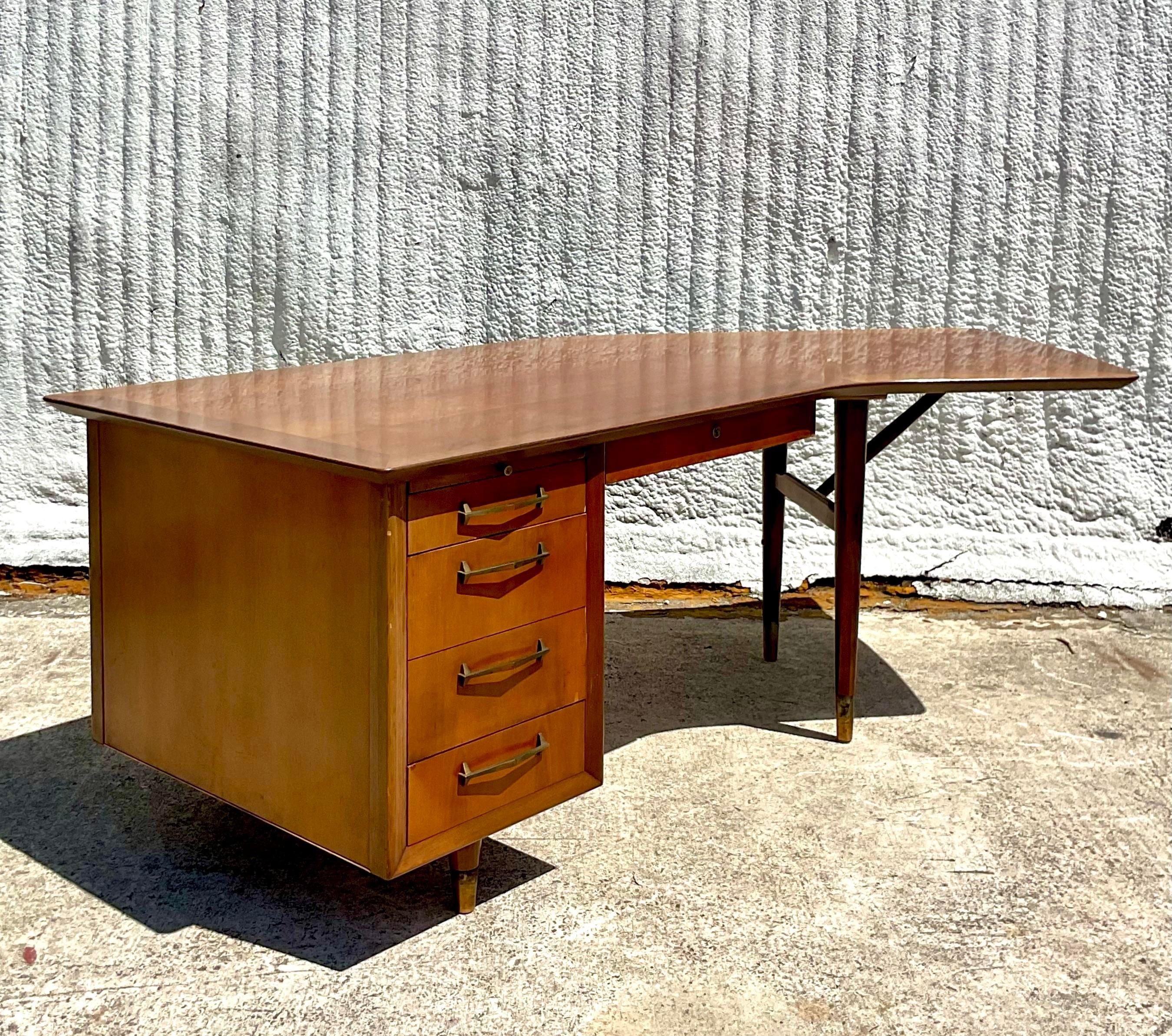 A striking Vintage MCM executive desk. Made by the iconic Alma group. Beautiful walnut frame in a chic boomerang shape. Marked inside the top drawer. Acquired from a NY estate.