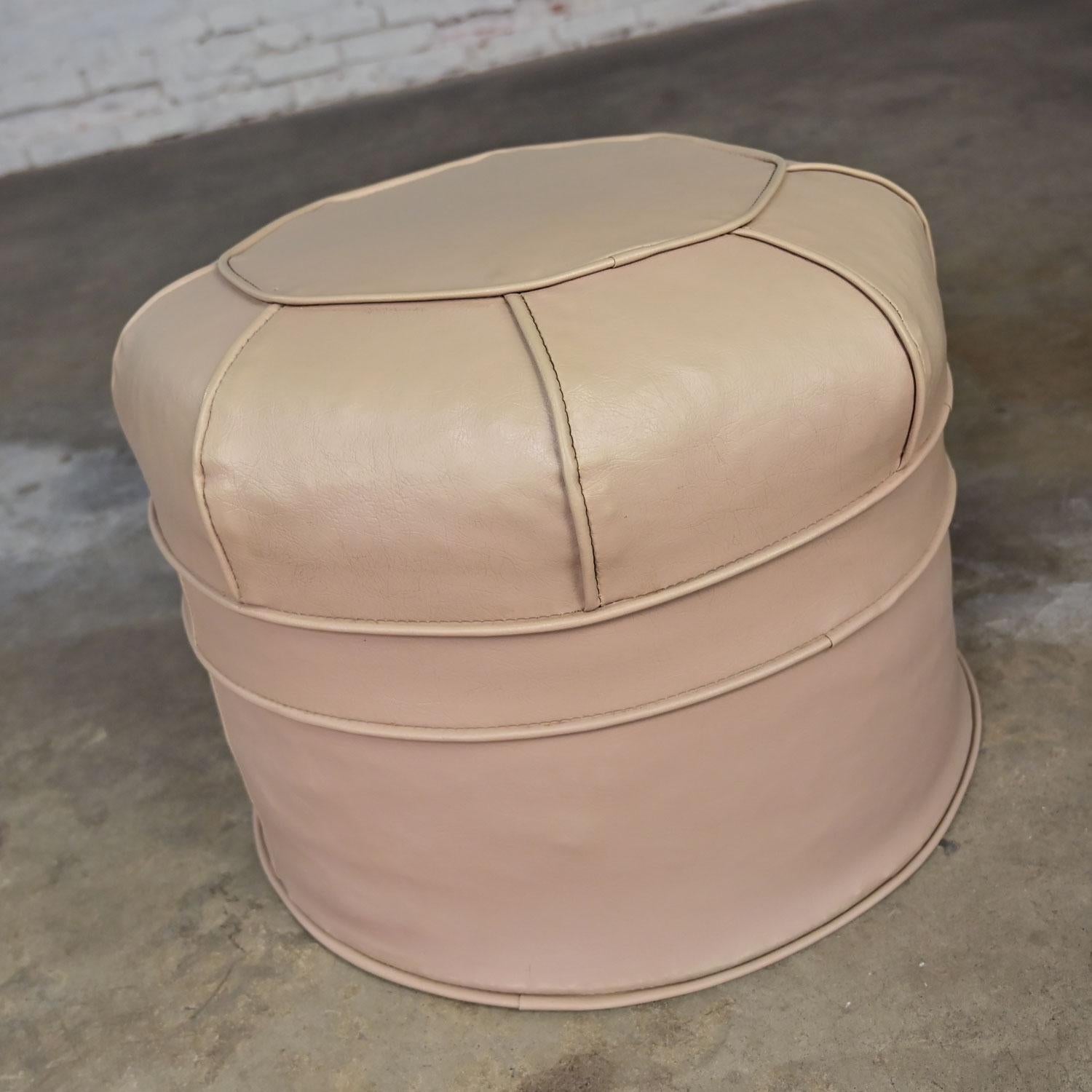 Awesome vintage Mid-Century Modern beige faux leather or vinyl octagonal hassock, ottoman, or footstool. Beautiful condition, keeping in mind that this is vintage and not new so will have signs of use and wear. We have found no outstanding flaws.