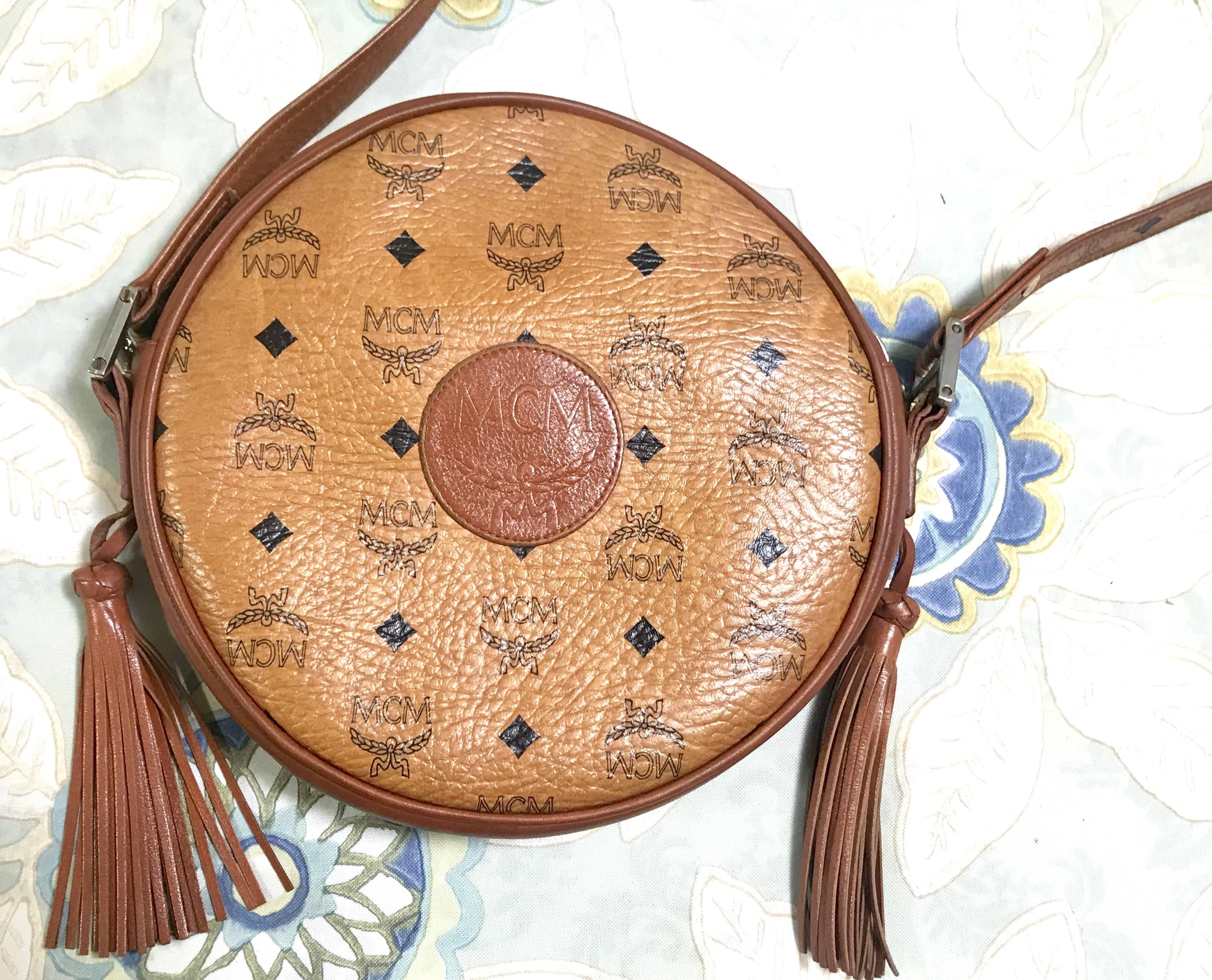 1990. Vintage MCM brown monogram round Suzy Wong shoulder bag with brown leather trimmings. Designed by Michael Cromer. Masterpiece. Unisex use.

MCM has been back in the fashion trend again!!
Now it's considered to be one of the must-have designer