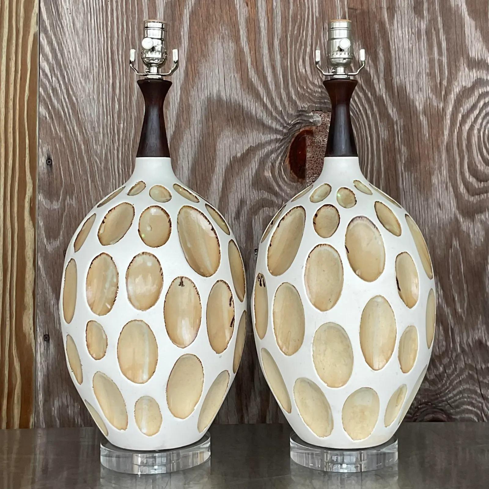 A fantastic pair of vintage MCM table lamps. Beautiful crater design with a matte glazed finish. Fully restored with all new hardware and wiring. Acquired from a Palm Beach estate.