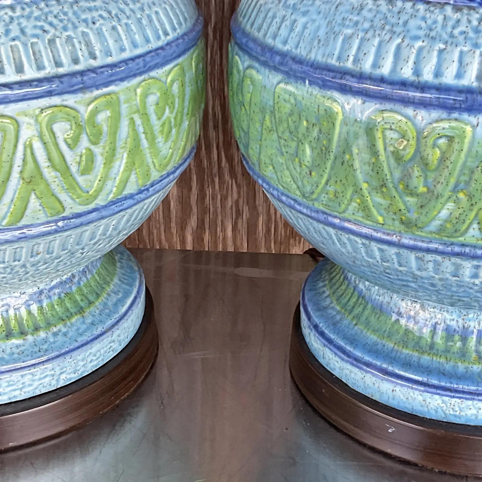 Outstanding pair of Midcentury table lamps. A brilliant blue green design with relief details. Acquired from a Palm Beach estate.

The lamps are in great vintage condition. Minor scuffs and blemishes appropriate to their age and use.

The vendor