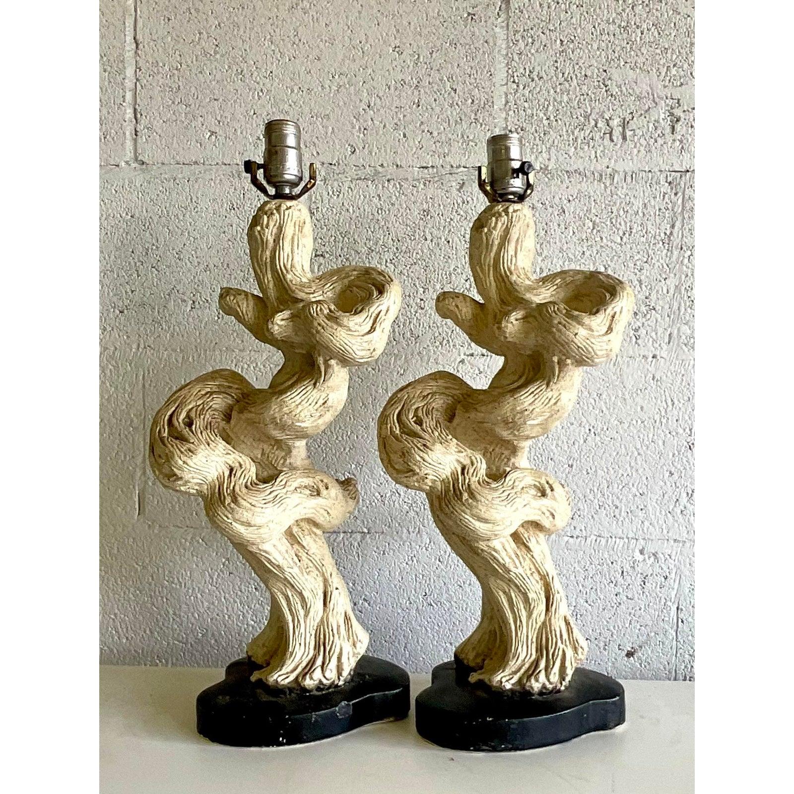 A fantastic pair of MCM table lamps. A chic period design of driftwood in a glazed ceramic. Acquired from a Palm Beach estate.