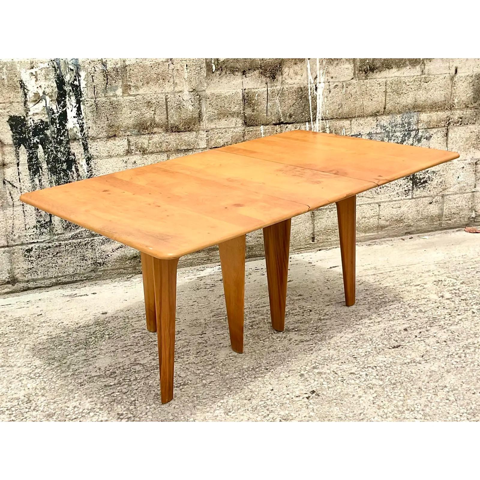 Fantastic vintage MCM dining table. Made by the iconic Heywood Wakefield. Beautiful drop leaf design makes this perfect for city apartments. All the joys of a large dining table with the ability to drop the sides and slip into a small area. Looks
