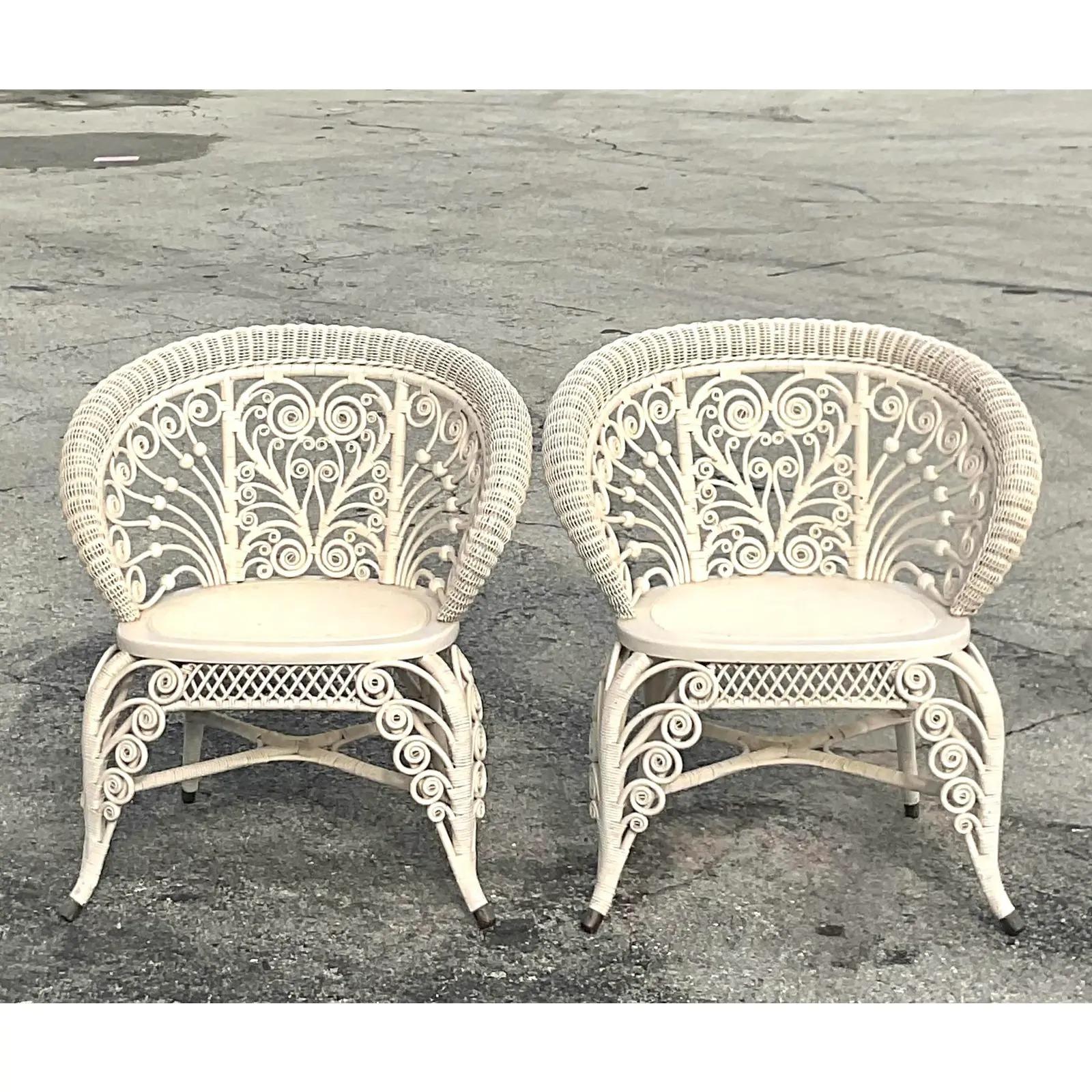 A fabulous pair of vintage MCM Coastal Fiddle-Roe chairs. Made by the iconic Heywood Wakefield group. Beautiful woven rattan in the classic swirl design. Original tag on the bottom of one of the chairs. Acquired from a Palm Beach estate.