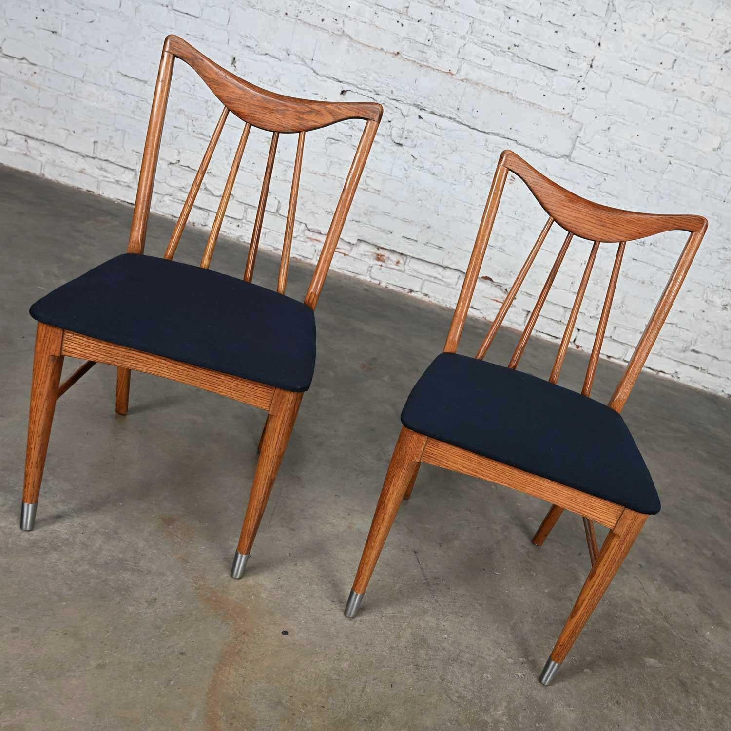 Handsome vintage Mid-Century Modern Keller furniture Valkerie II Line dining or side chairs by Edmond J. Spence, a pair. Comprised of oak frames, blue fabric upholstered seats, and chrome sabots on the front feet. This piece has been attributed