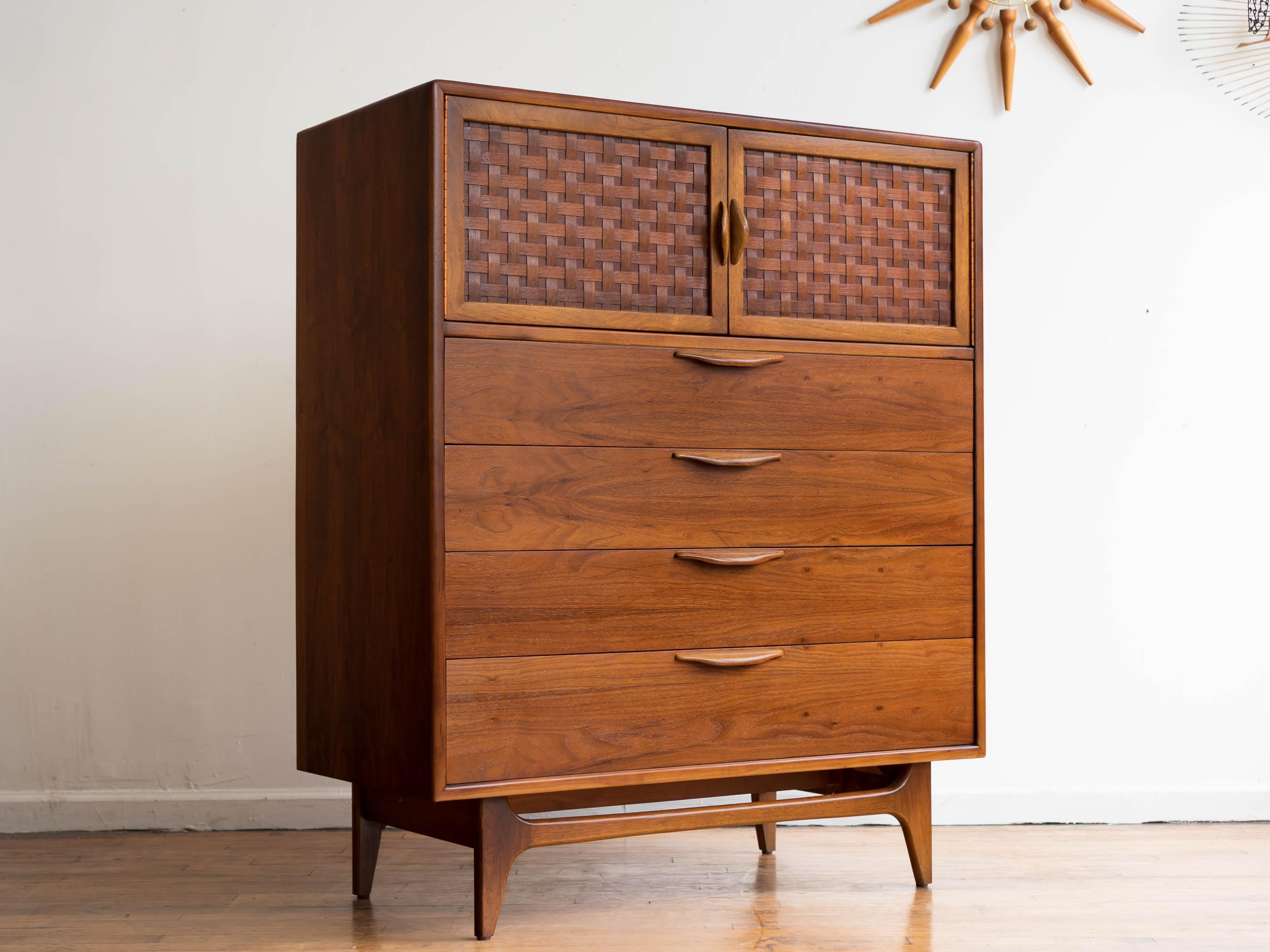 Measures: 40” x 19” x 48” H

This striking piece features two doors that open up to reveal a spacious storage area with a shelf, along with three drawers below for additional storage space. The chest is crafted from durable walnut with a natural