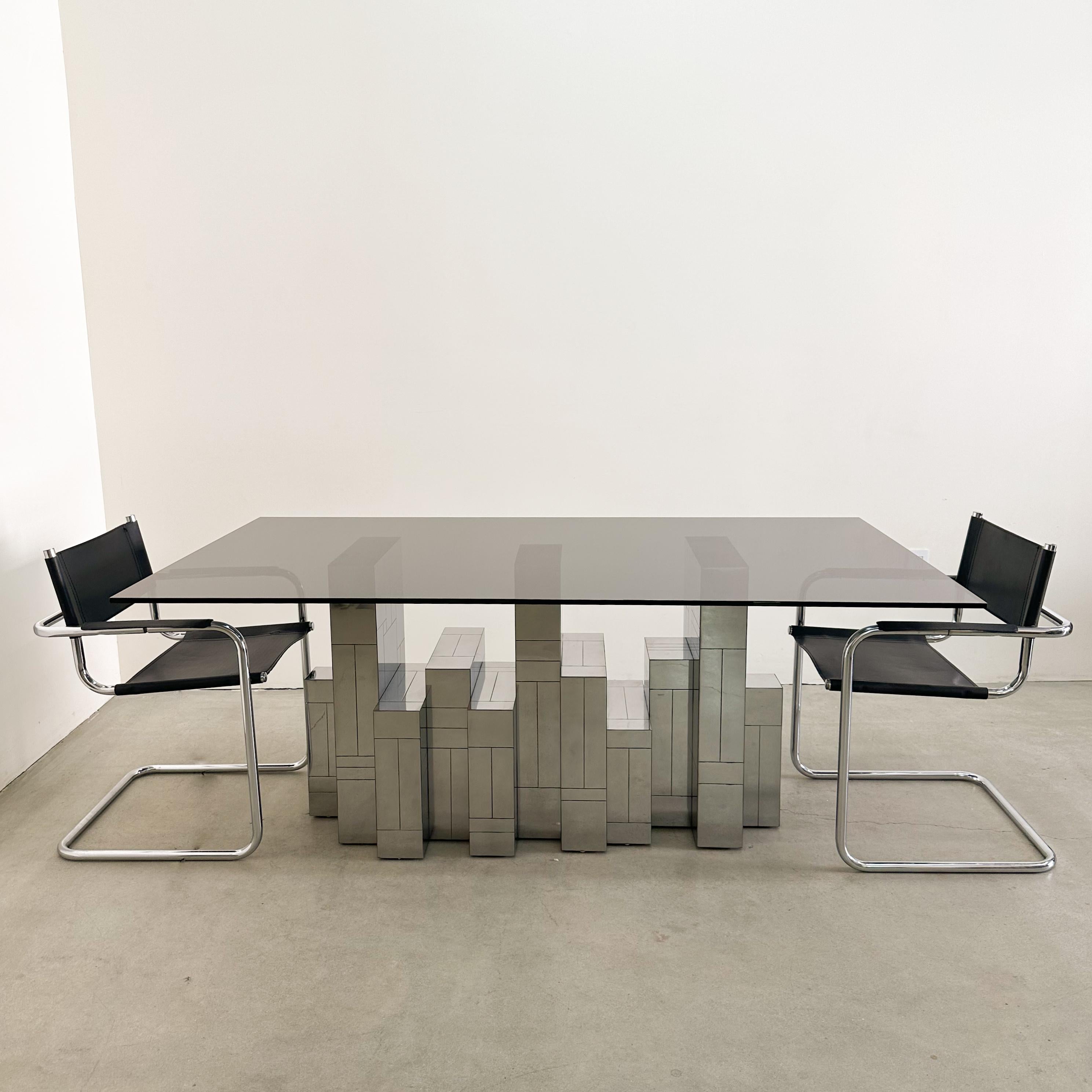 Beautiful vintage Mid-Century Modern Paul Evans “Cityscape” dining table in a polished gunmetal finish. The table is signed and features a brand-new smoke glass top, perfectly complementing the sculptural geometric base. Created in the 1970s, this