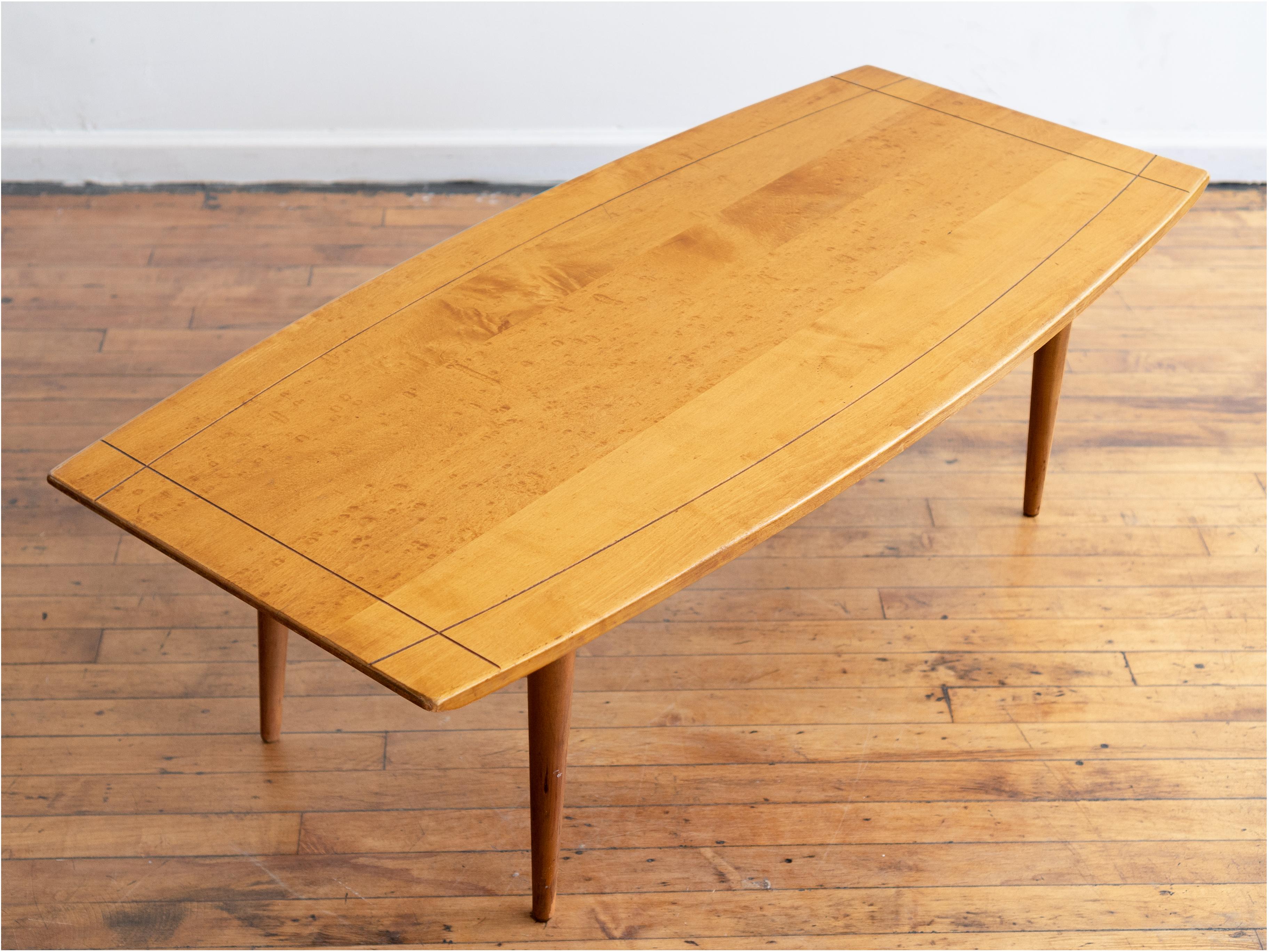 48” x 22” x 15”H  

Super cute, petite surfboard coffee table in the style of Paul McCobb's Planner Group furniture. Solid birdseye maple in a natural finish. Legs attach via hand-carved wooden threads that lock into matching sockets

Good vintage