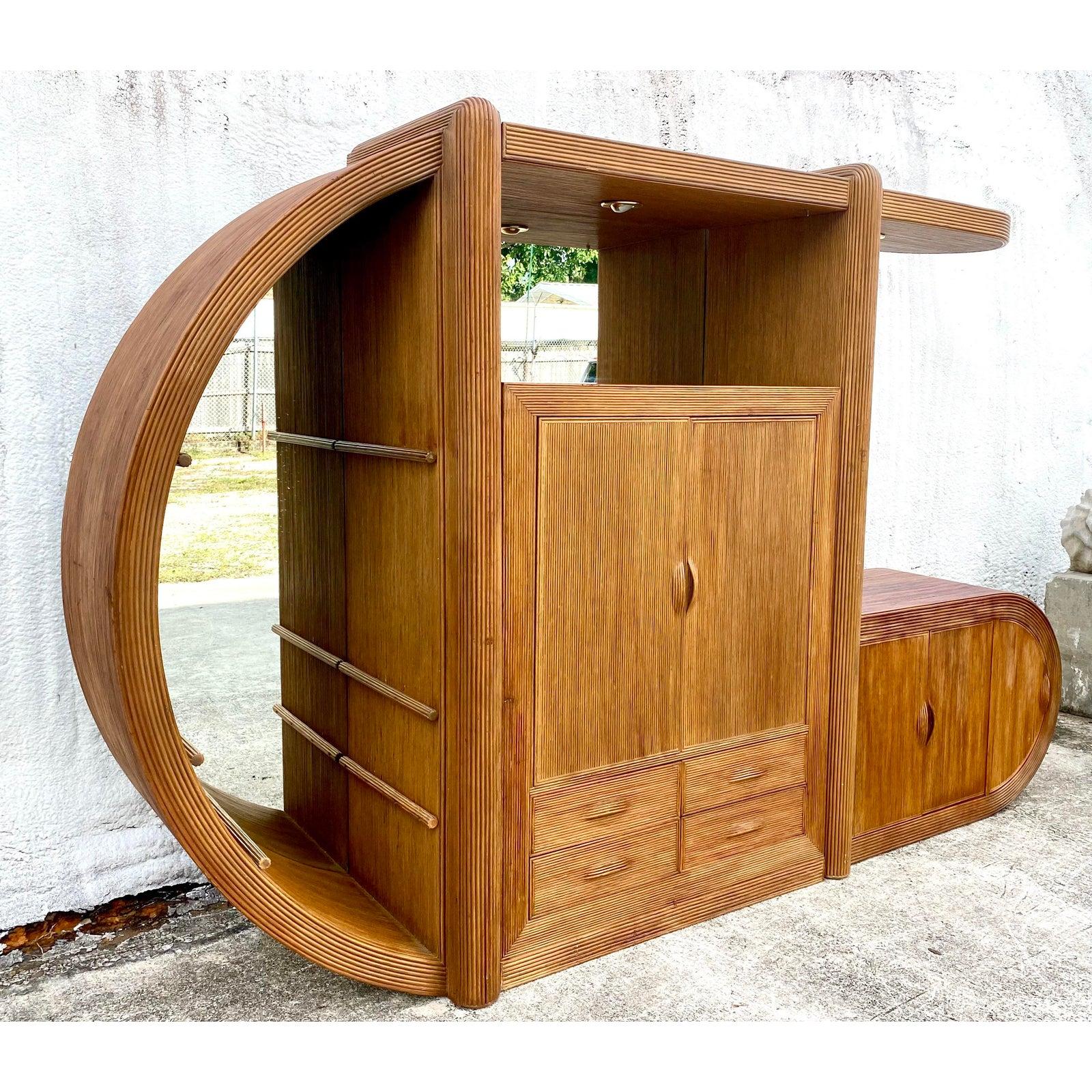 Incredible vintage MCM wall unit. Beautiful pencil reed frame in a fantastic organic shape. Striking and dramatic arch with lots of practical storage. Glass shelves in the half moon section and mirrored back walls on the first two sections. Acquired