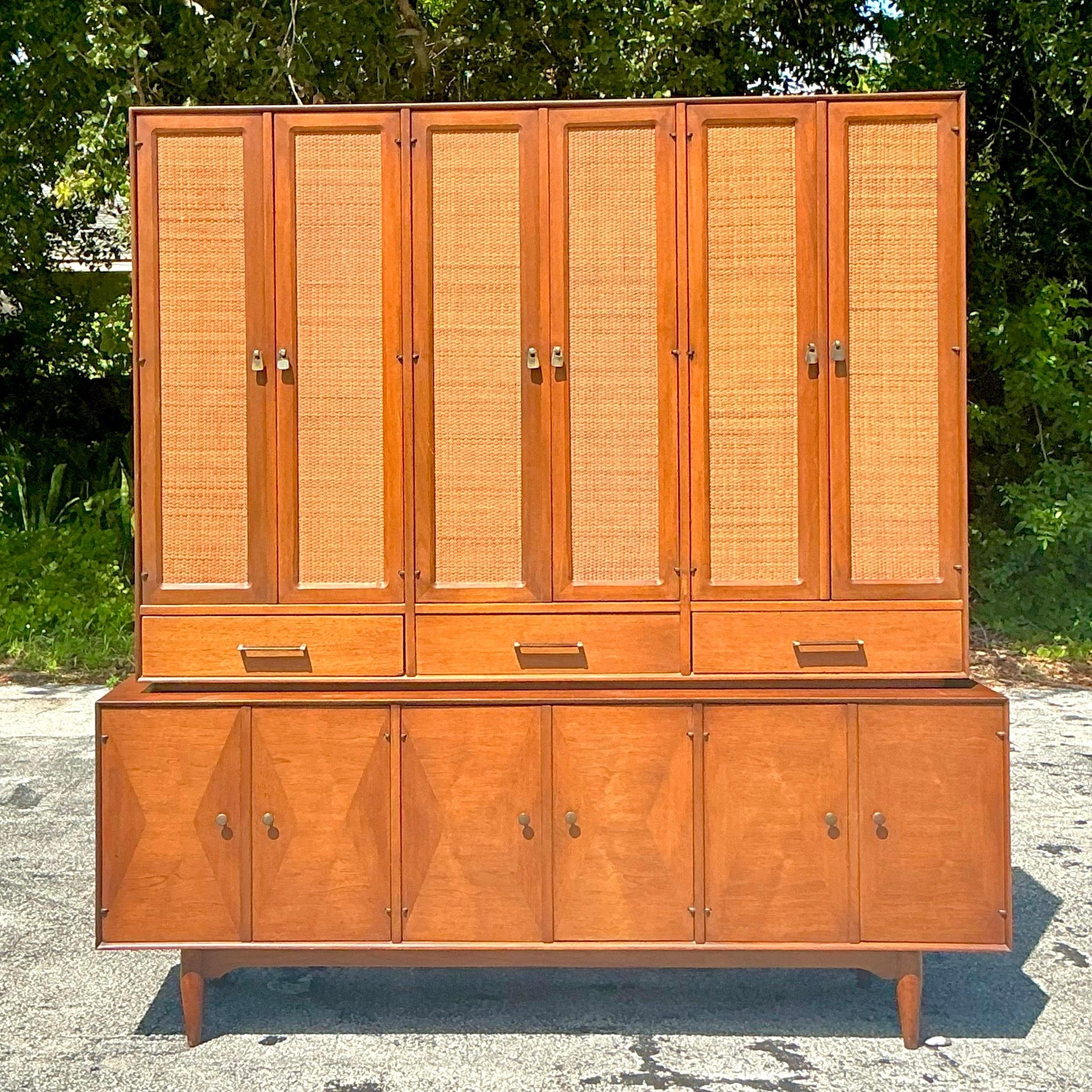 Vintage Mid-Century Modern Ramseur china cabinet, featuring a sleek design with seagrass accents, offering a stylish blend of natural texture and modern elegance for your dining space.