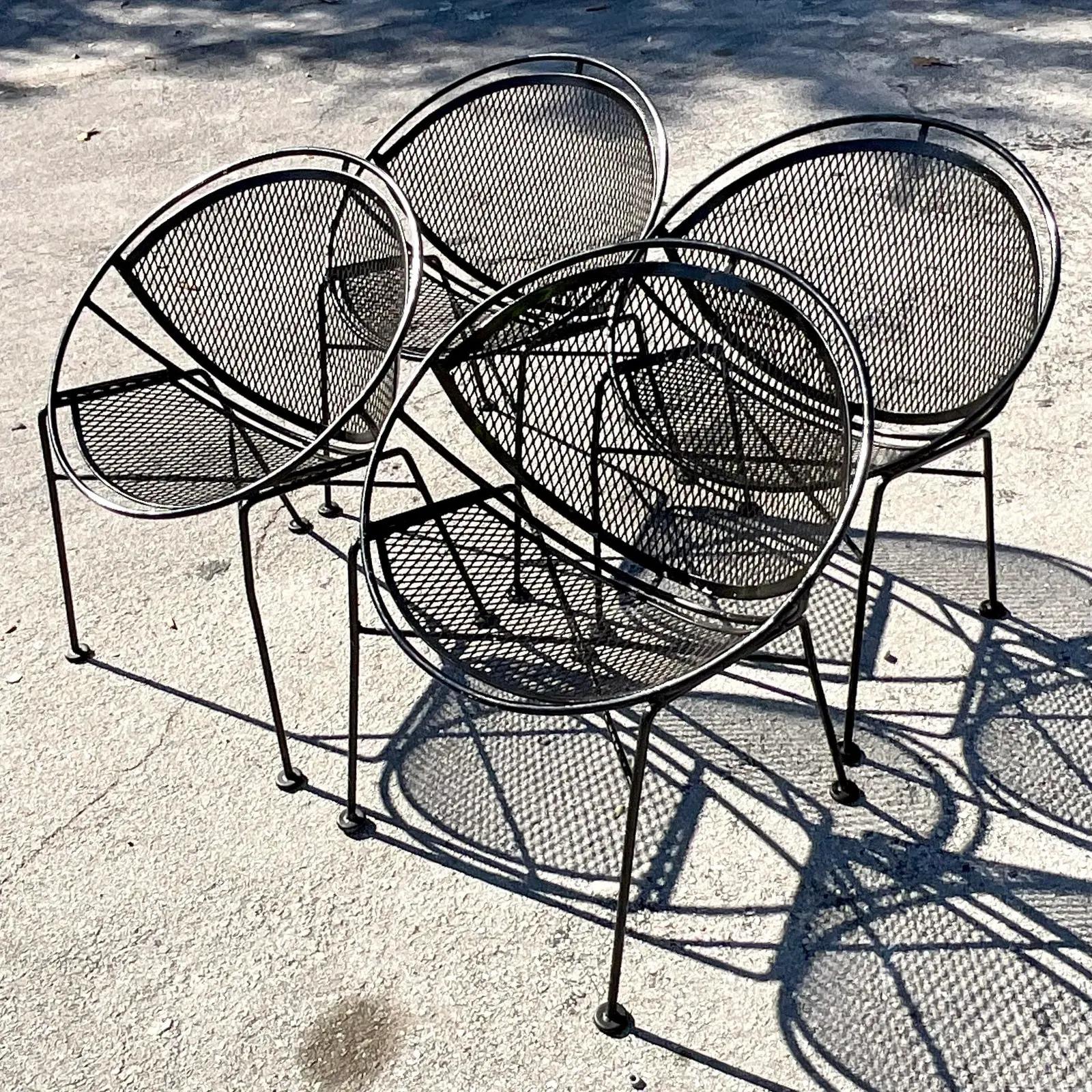 A fabulous set of four vintage MCM outdoor chairs. Made by the iconic Salterini group. The coveted “Radar Hoops” style in gloss black. Unmarked. All feet intact. Acquired from a Palm Beach estate.
