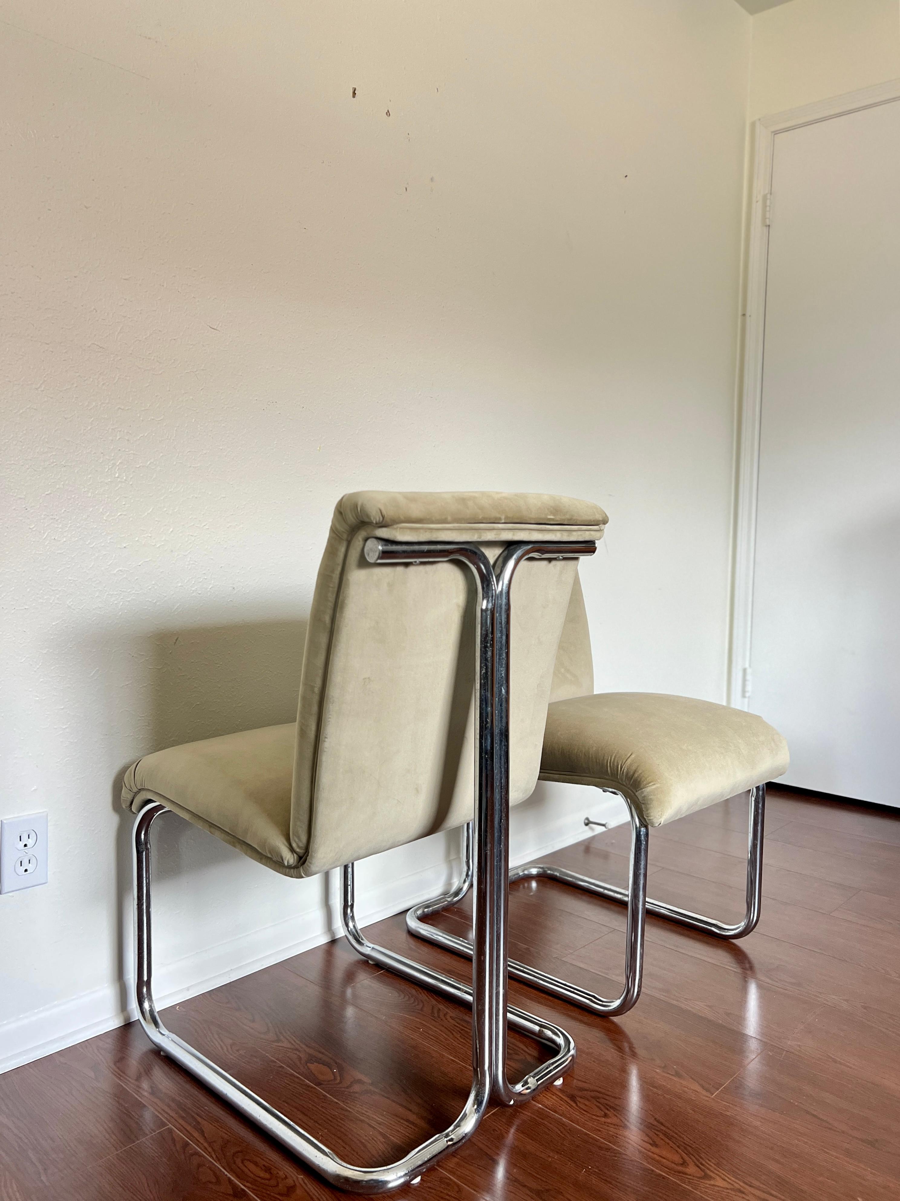 Vintage Milo Baughman style chrome and velvet dining chairs. There are 4 total, and are all reupholstered in 100% cotton velvet in a pale mossy green. Overall in good condition, and structurally sound. Chrome has some wear.
 Dimensions: 
34” H x