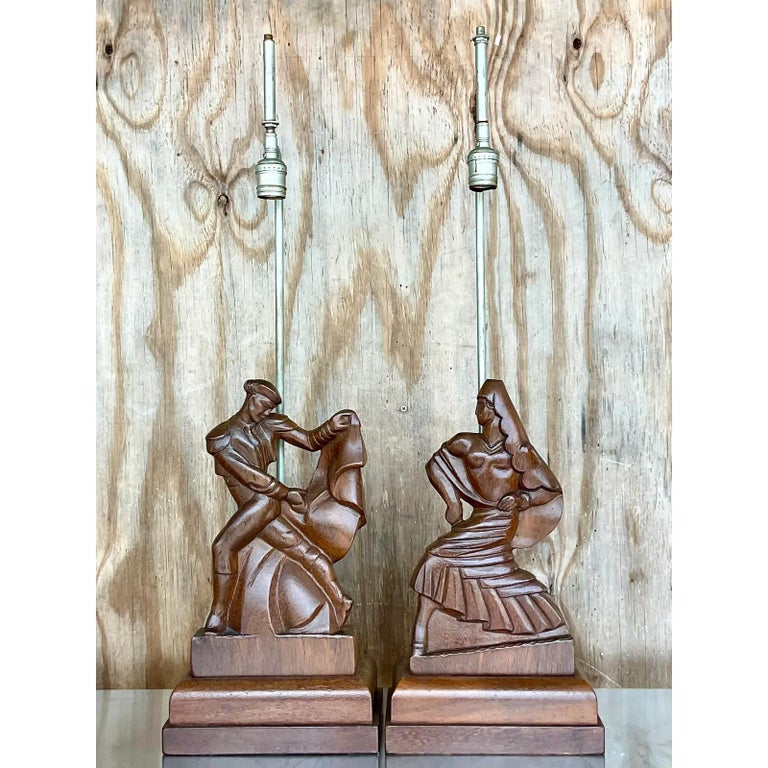 Incredible pair of vintage hand carved table lamps. Made by the highly collectible Heifetz group and signed on the back. A beautiful composition of a dancer couple. Original hardware. Acquired from a Palm Beach estate.