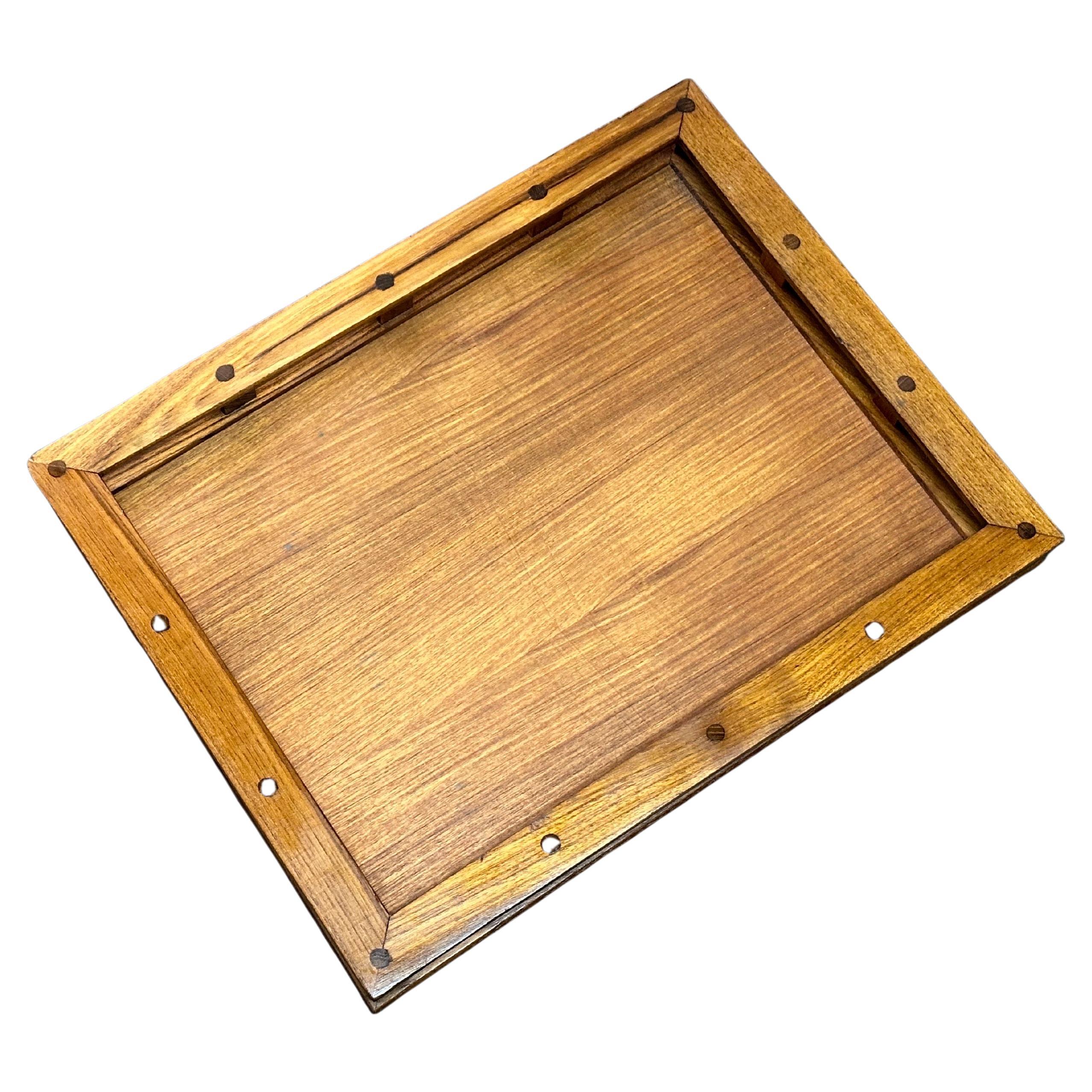 Vintage MCM teak serving tray with rails by Dansk, circa 1980s.  This piece is well crafted in solid teak wood and built in rail styled handles. The piece has pegged detail construction that finishes a beautiful look. Branded mark to the verso