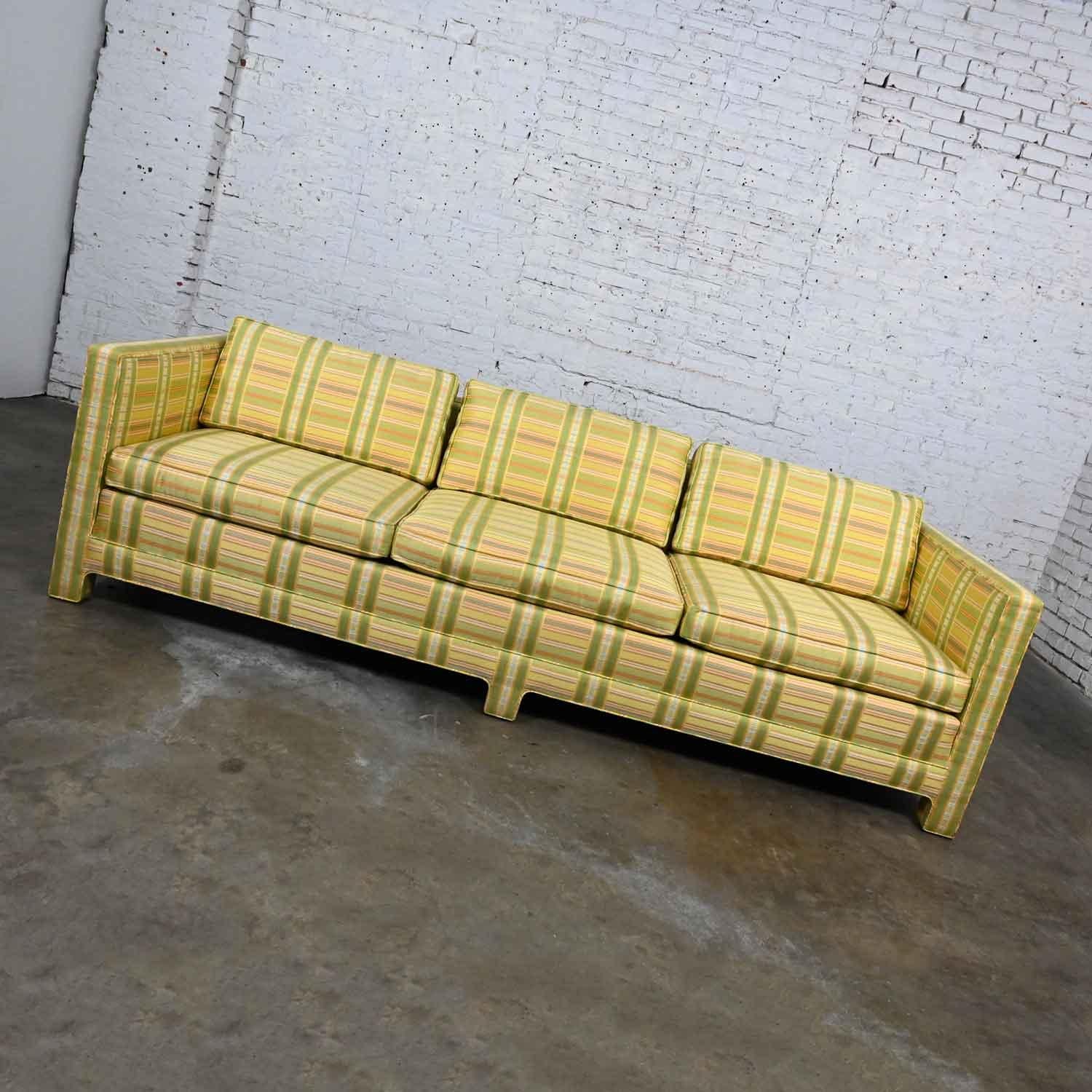 Gorgeous Mid-Century Modern (a.k.a. MCM) to modern tuxedo sofa by Henredon comprised of a fully upholstered frame including three loose seat & three loose back cushions wearing the original yellow and chartreuse with a touch of orange plaid fabric.
