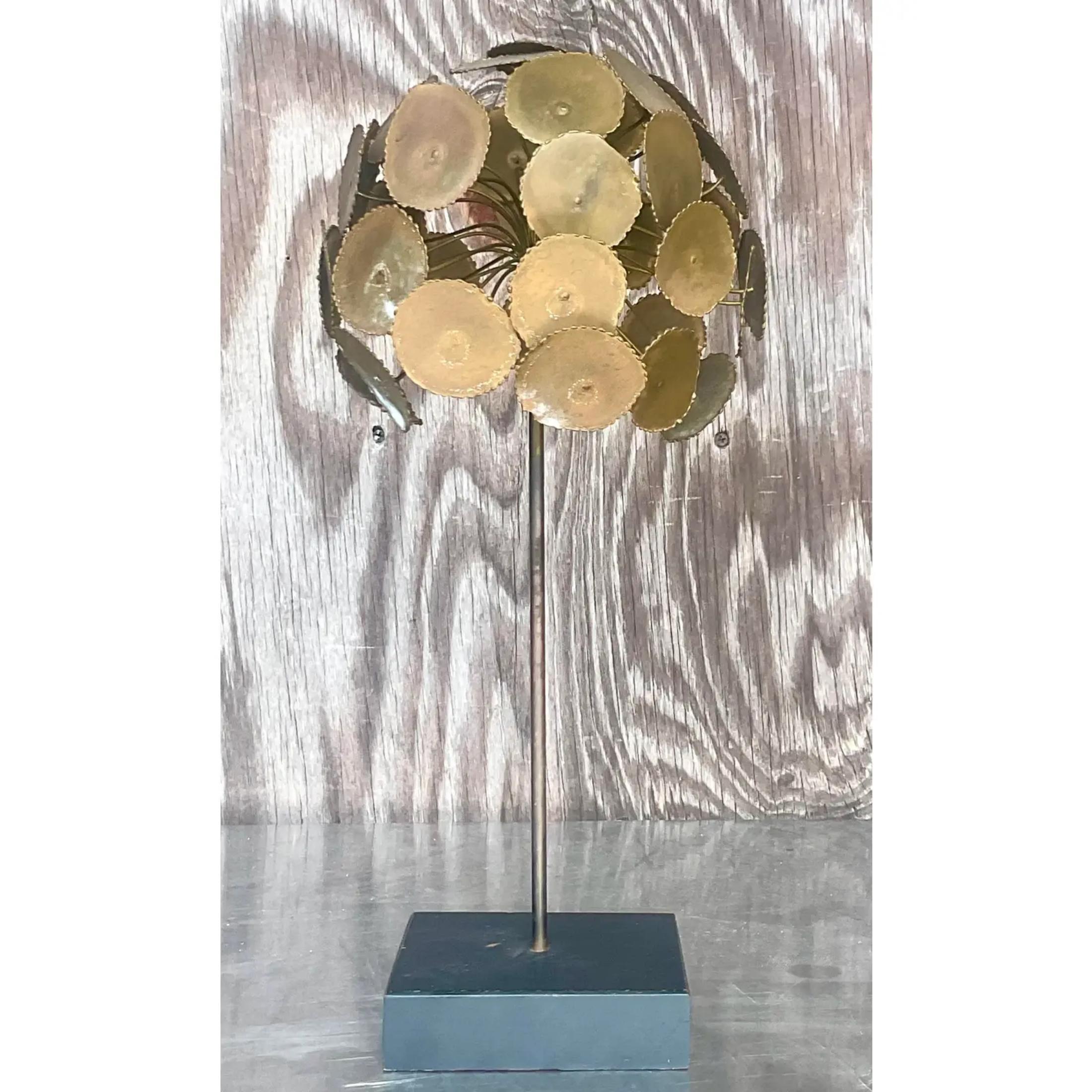 A fabulous vintage MCM sculpture. A chic little torch cut tree with rings of brass. Rests on a wooden block plinth. Acquired from a Palm Beach estate