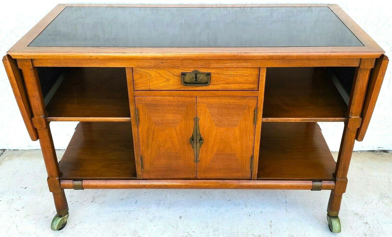 For full item description be sure to click on CONTINUE READING at the bottom of this listing.
Offering one of our recent palm beach estate fine furniture acquisitions of a vintage MCM walnut rolling sideboard buffet dry bar

Featuring solid wood