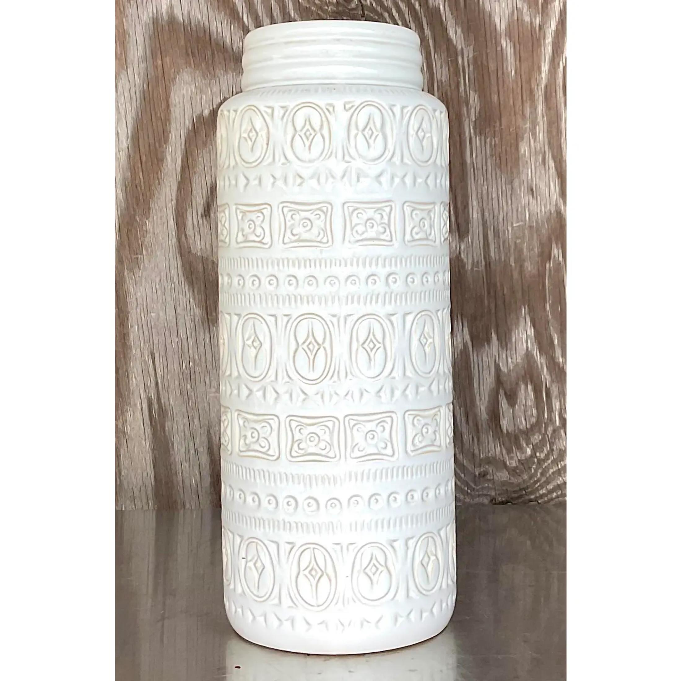 A fantastic vintage MCM table vase. An iconic West German design with a repeating ring of design characters. A beautiful neutral color that will blend easily into so many looks. Marked on the bottom. Acquired from a Palm Beach estate