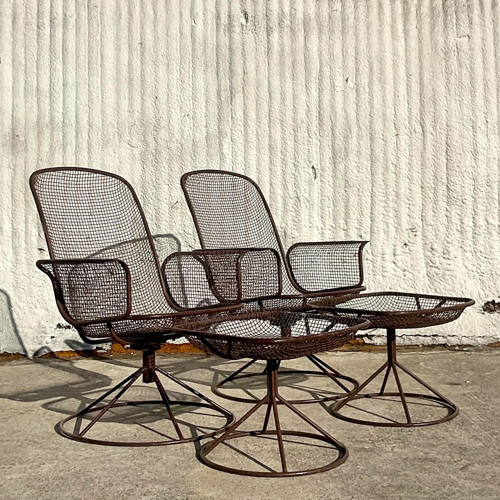 Vintage pair of MCM lounge chairs and ottomans. Chic wire mesh on two high back swivel chairs with matching ottomans. Done in the manner of the iconic Russell Woodard. Unmarked. Acquired from a Palm Beach estate.