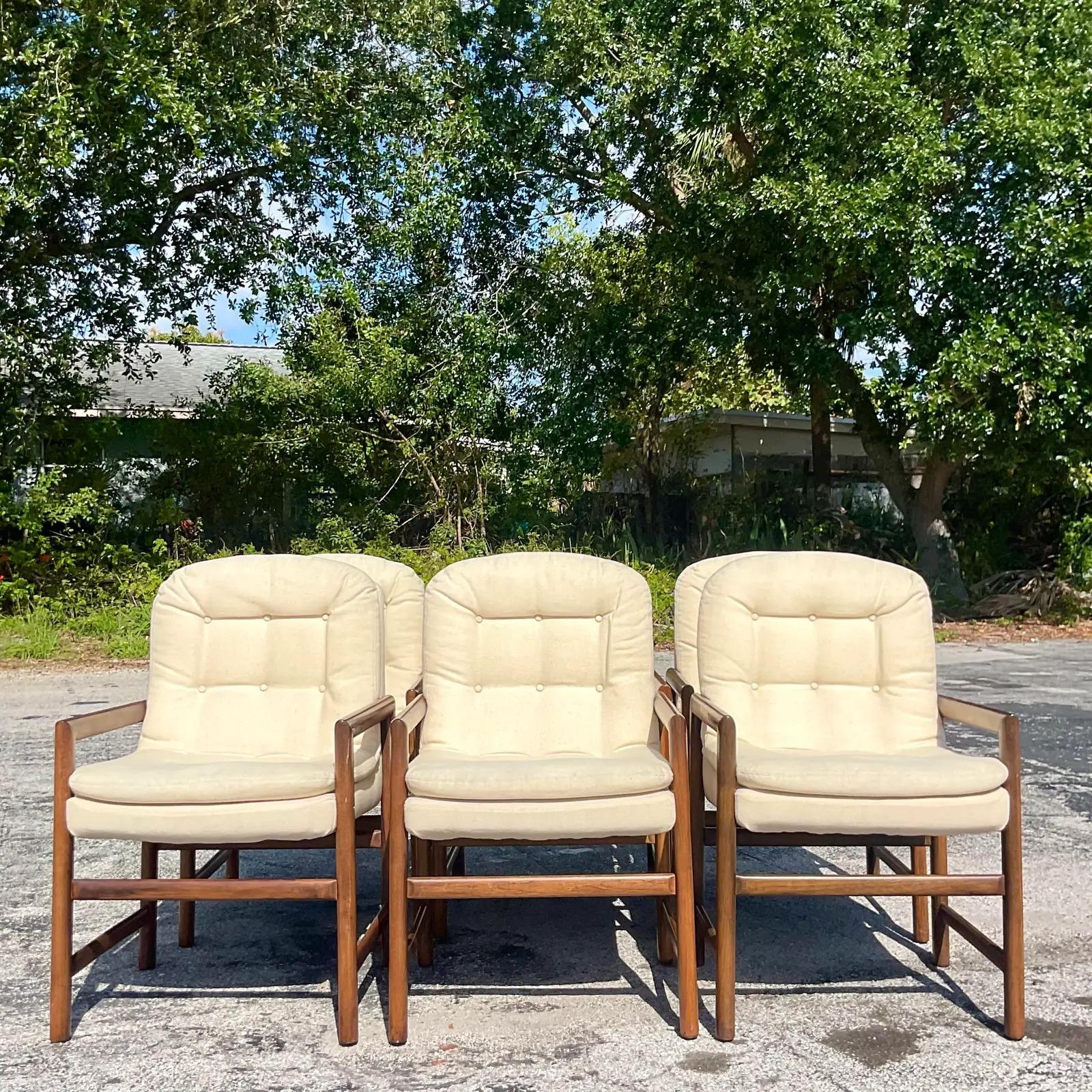 An incredible set of six vintage MCM dining chairs. A chic wooden frame with beautiful wood grain detail. A recently upholstered sling seat with channel tufted detail. Acquired from a Palm Beach estate.