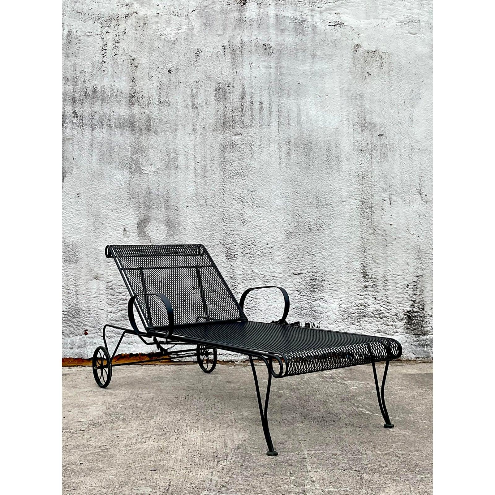 Elevate your outdoor or indoor lounging experience with this stunning vintage mid-century modern wrought iron chaise lounge, crafted in the iconic style of Russell Woodard. Showcasing timeless design and exceptional craftsmanship, this piece