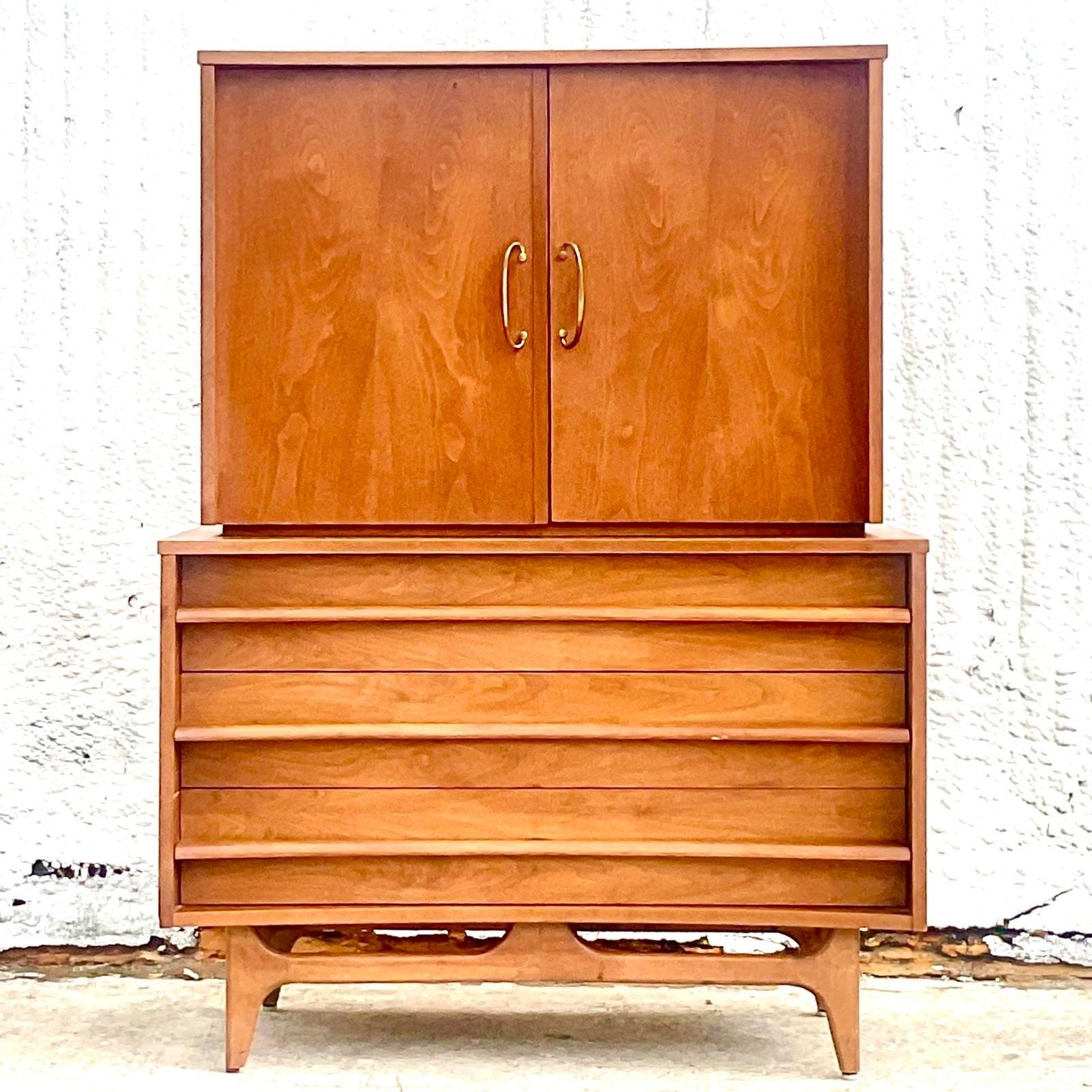A fabulous vintage MCM Gentleman’s chest of drawers. Made by the iconic Young Young group. Beautiful tall chest with interior drawers and shelving. Acquired from a Palm Beach estate.