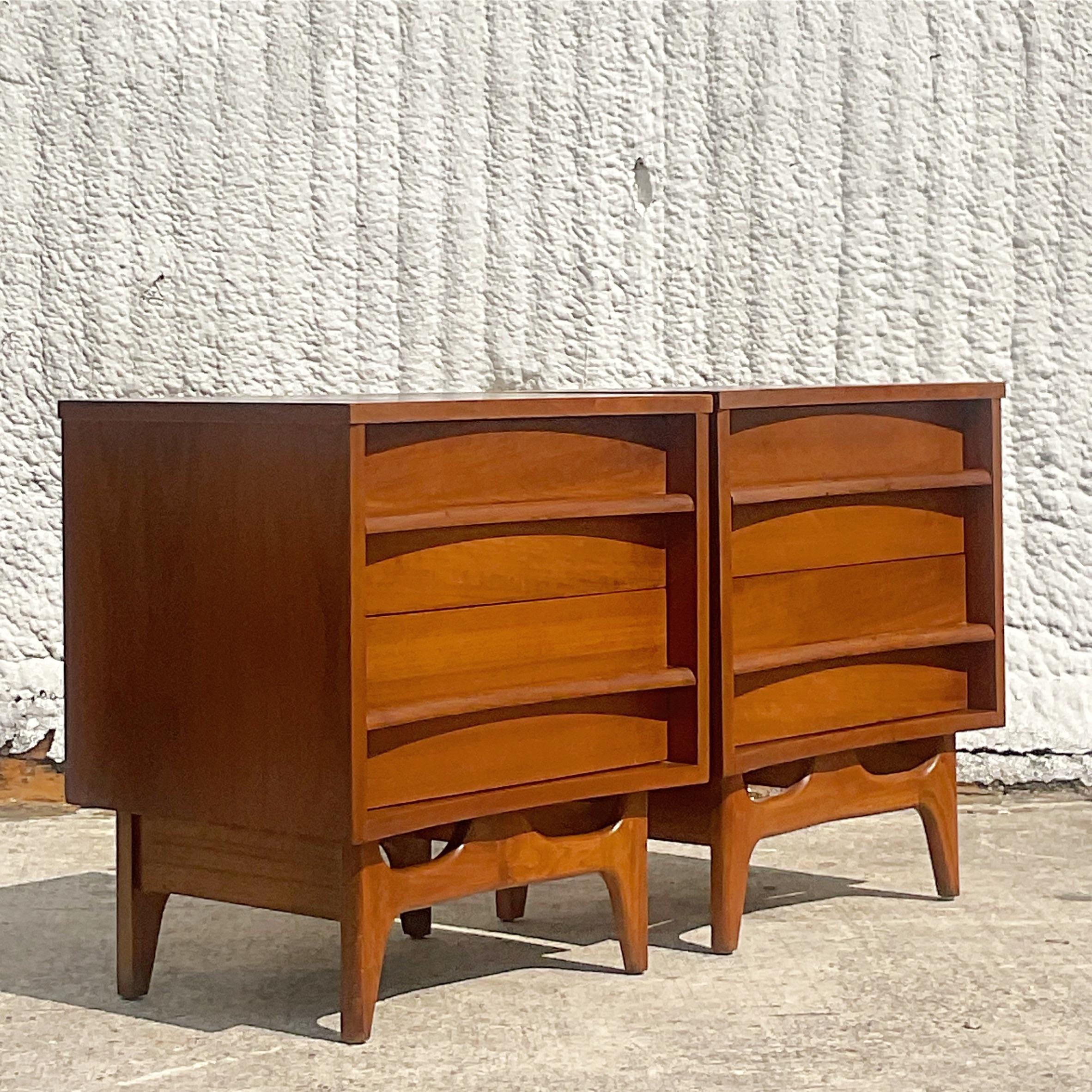 A fantastic pair of vintage MCM nightstands. Made by the iconic Young Manufacturing group. Beautiful two drawer design resting on a pierced apron. Acquired from a Palm Beach estate.