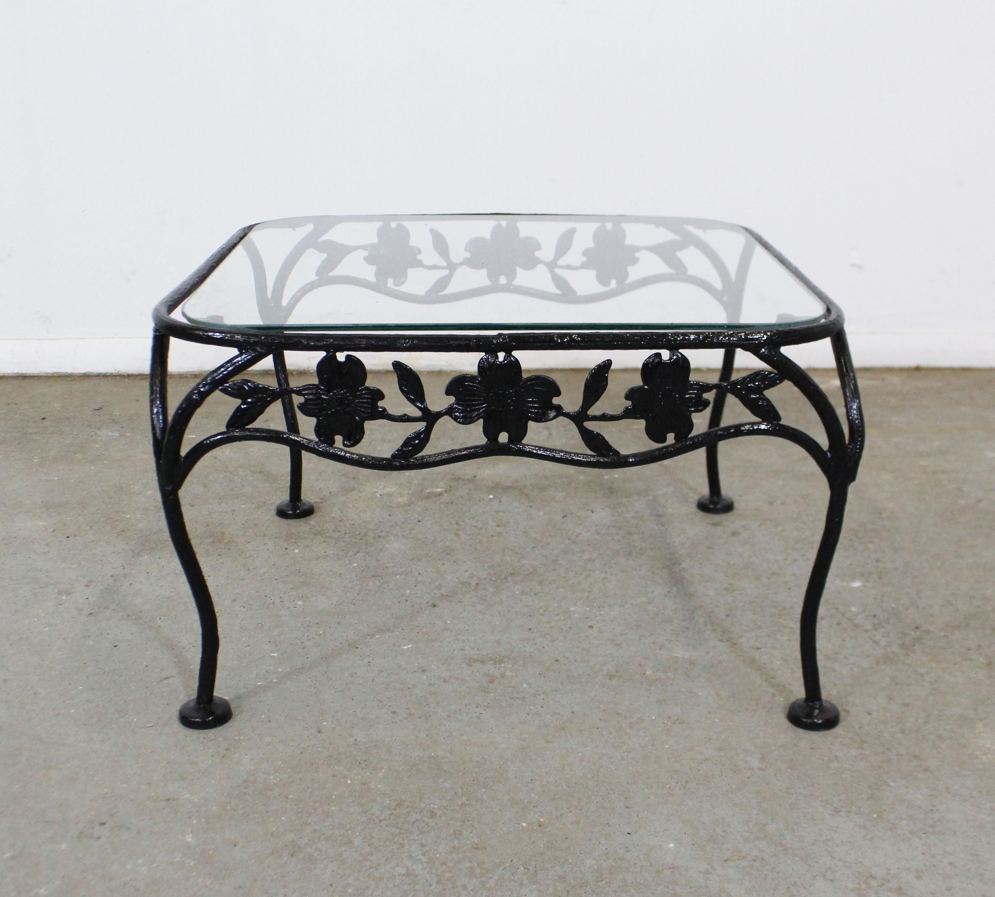 What a find. Offered is a vintage wrought iron dining table with a dogwood-leaf design and a removable glass top. Perfect for an outdoor patio space! Attributed to Meadowcraft's 'Dogwood' line. It is in good condition with a repainted and