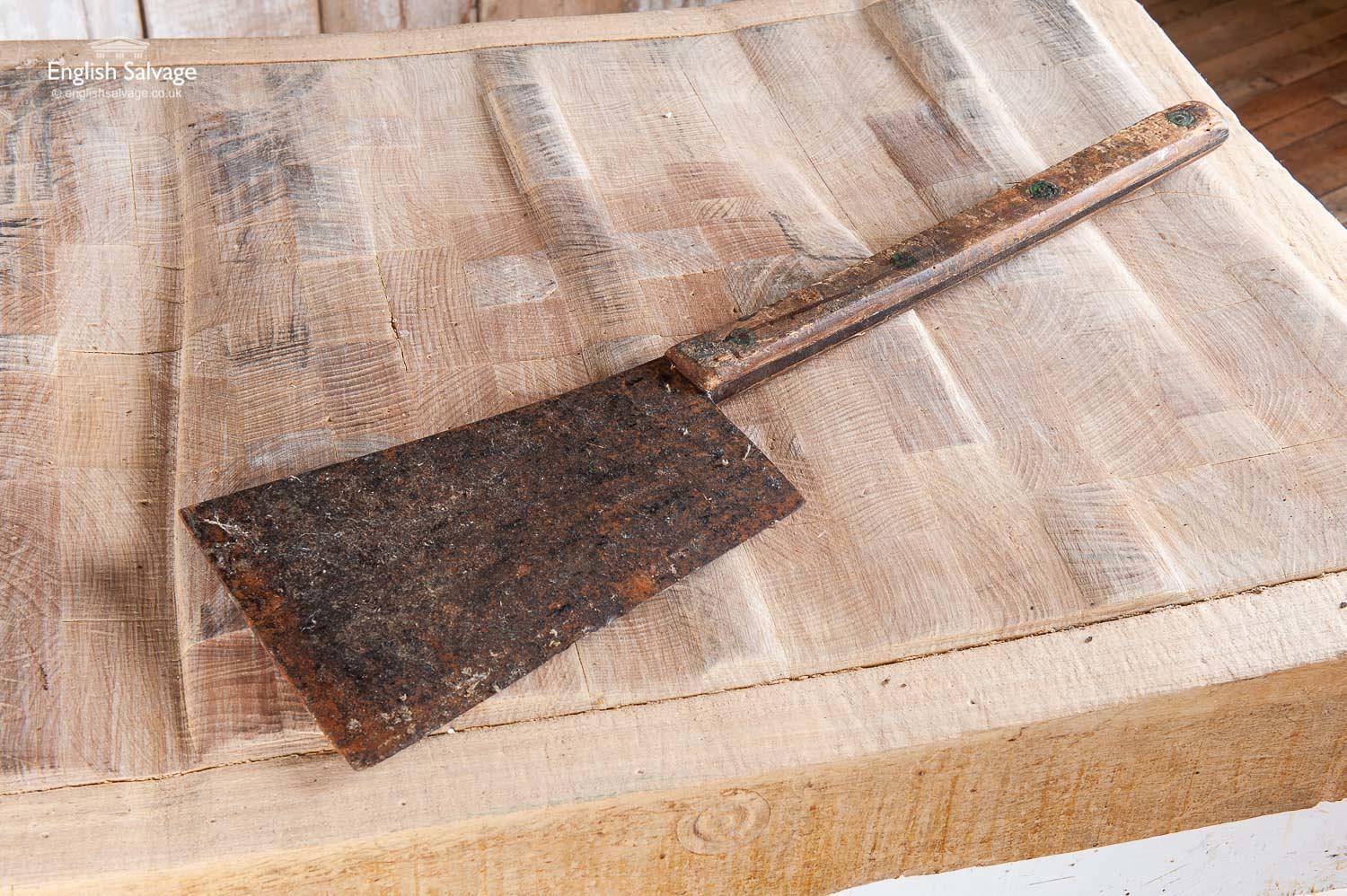 Vintage meat cleaver. It is pictured with a butcher's block which can be viewed here. It has an aged patina with surface rust and scratches to the wooden handle as it has seen plenty of use.