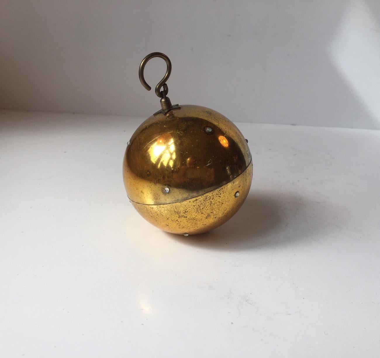 A string pull-up mechanical Christmas sphere playing Silent Night. Manufactured by Reuge in St. Croix Switzerland during the 1960s. This is the rare bejeweled version mimicking Christmas night. This object is in working order and is meant to be hung