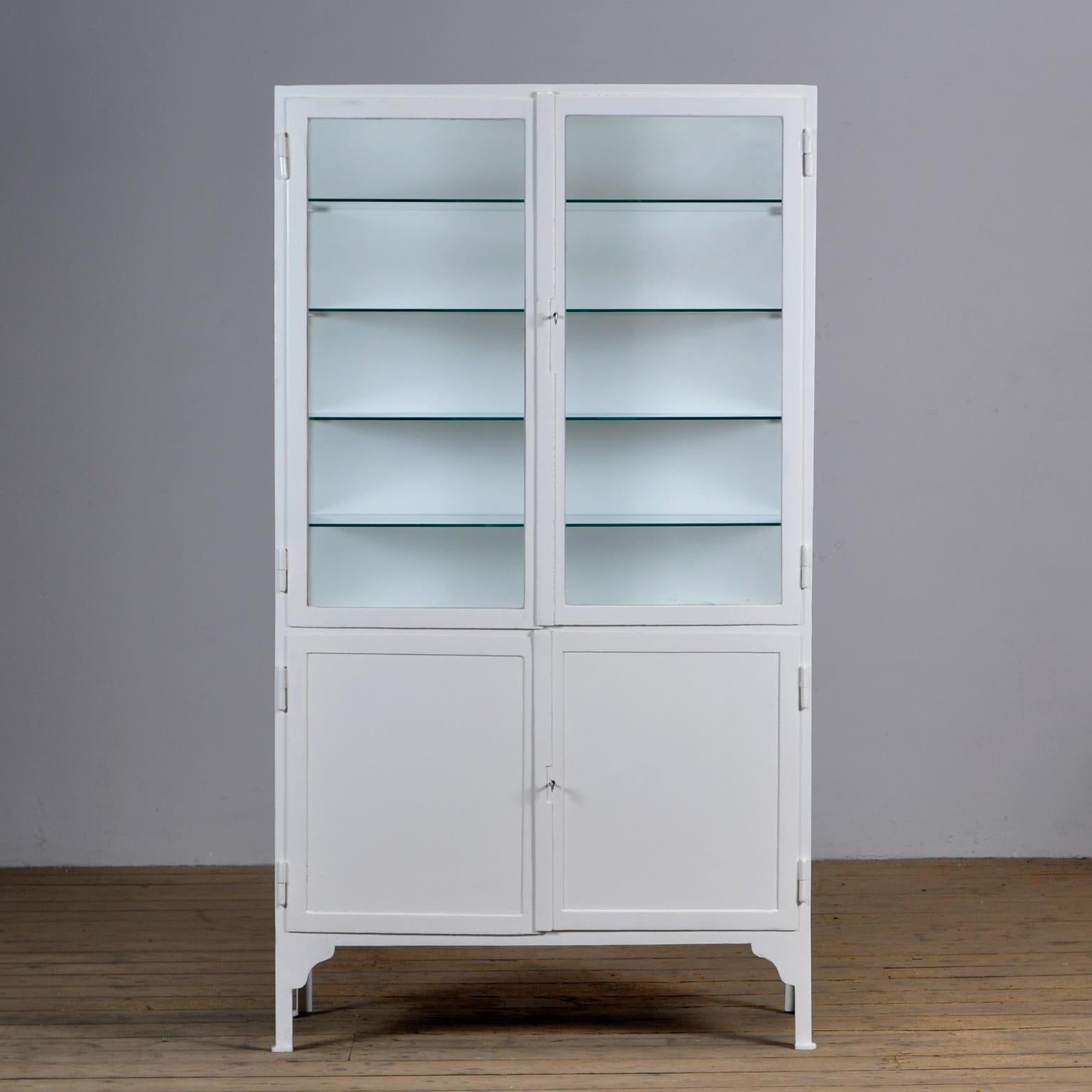 Medical cabinet from the 1930s. The cabinet is produced in Hungary and is made of thick iron and glass. The cabinet has recently been revarnished. Heavy quality, the cabinet weighs approximately 80kg.