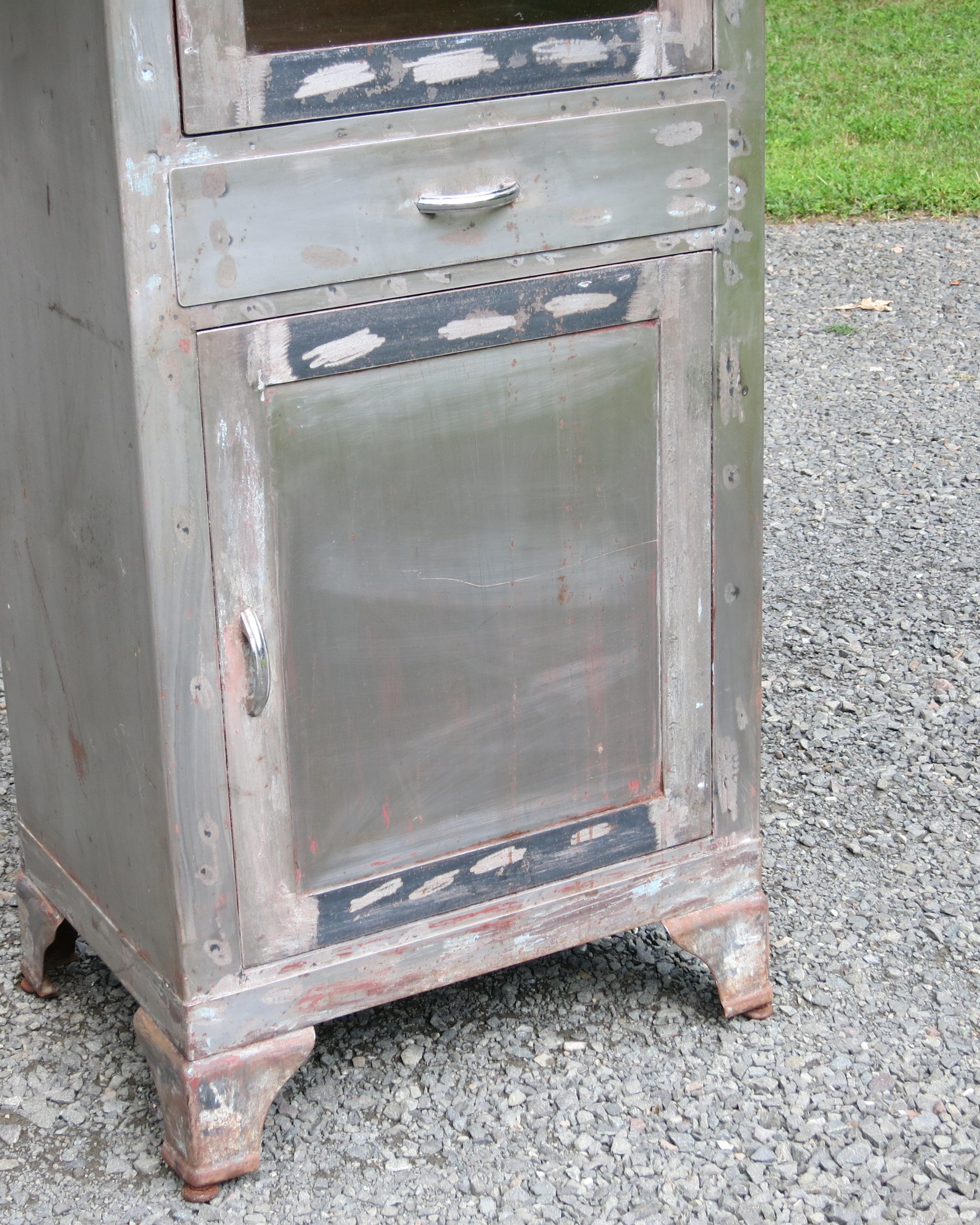 Vintage distressed medical cabinet. It is 22